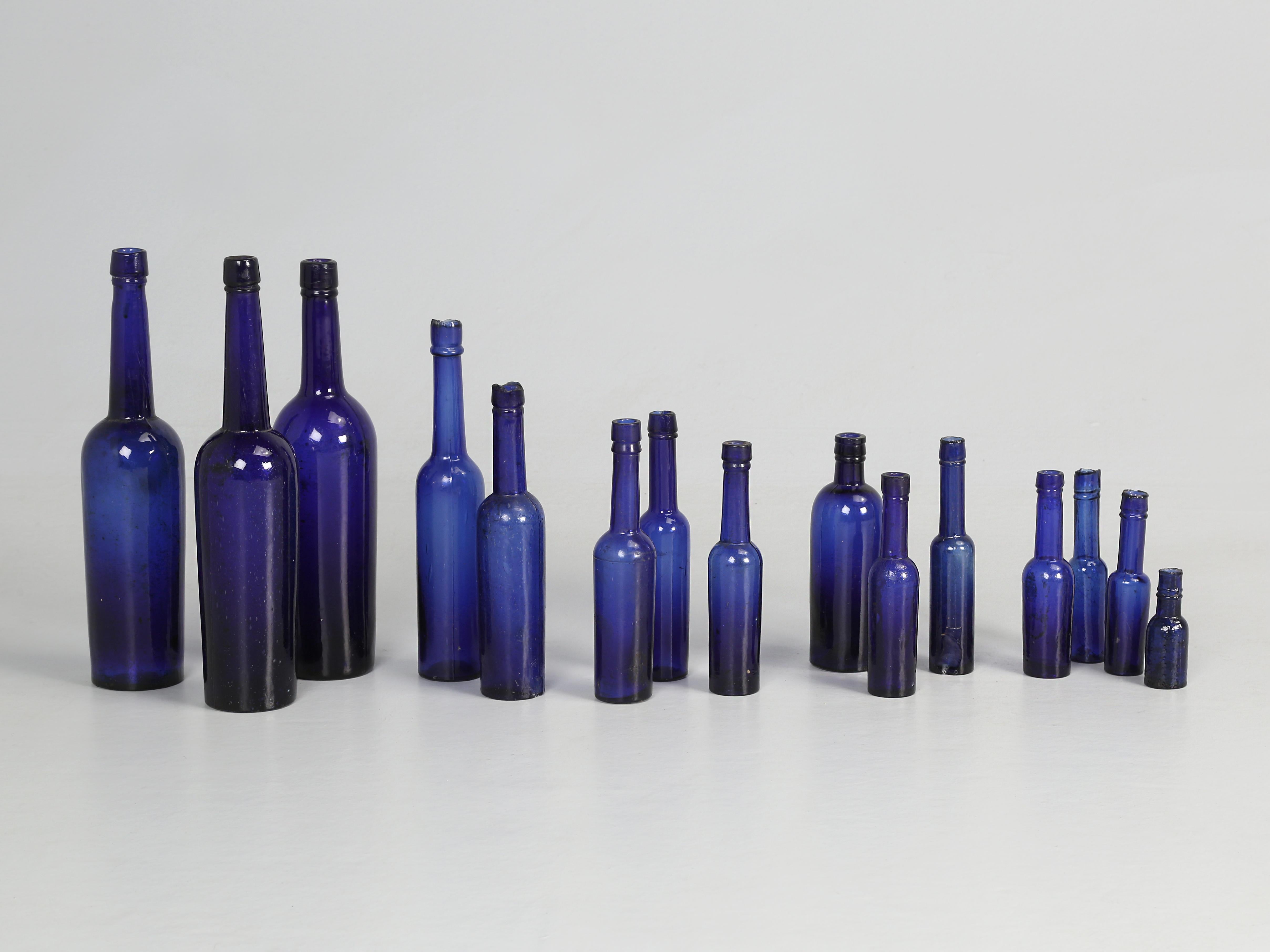 Incredible collection of (15) Cobalt blue hand blown caster oil bottles made in the late 1800s and Imported from Ireland. Wonderful as a splash of a fantastic shade of Cobalt Blue colour and the blues and greens are very in now. 
**Measurements