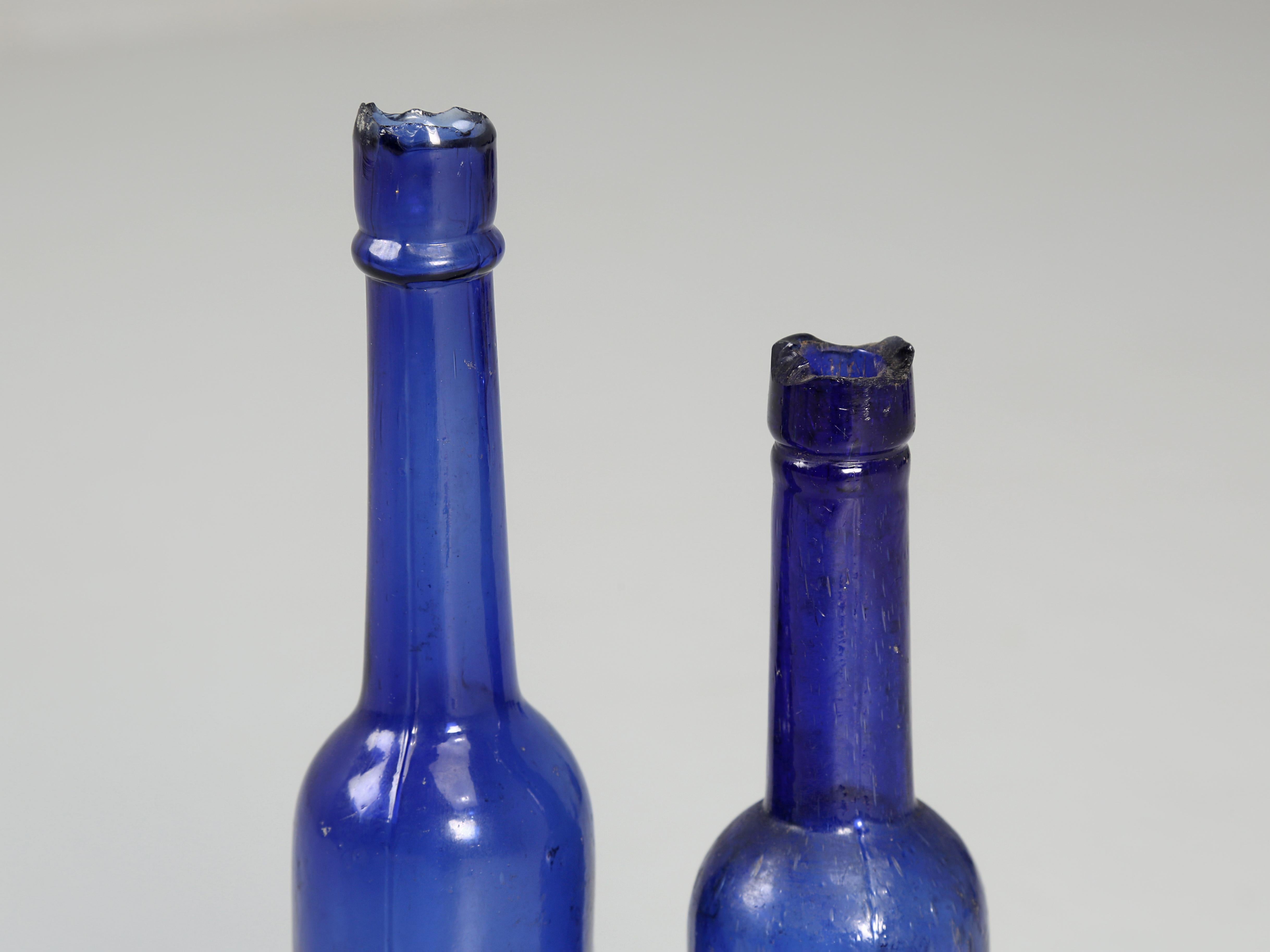 British Collection of '15' Cobalt Blue caster Oil Hand Blown Bottles Made in 1800s For Sale