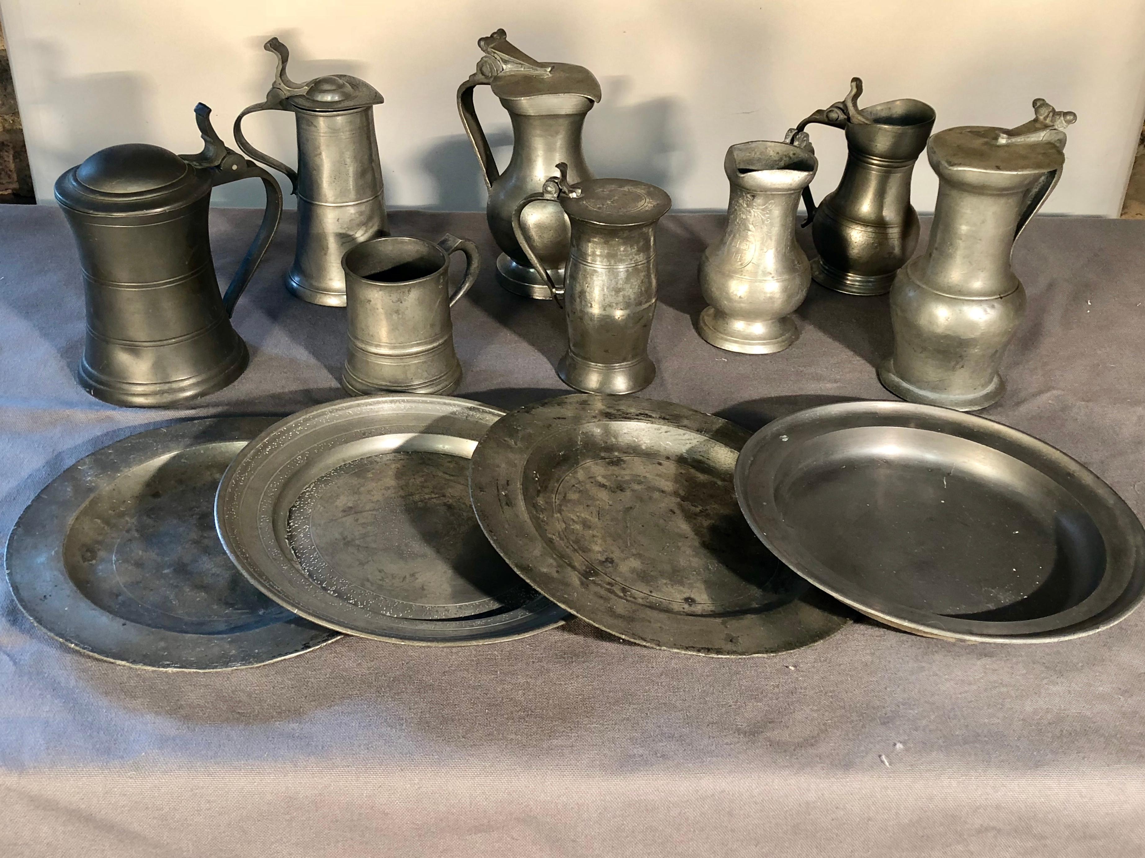 A collection of 12 pieces of American and European antique pewter tankards and plates, some with hallmarks and written descriptions taped inside. A quick way to fill that cupboard! Tallest is 7”. Plates are 9” diameter.