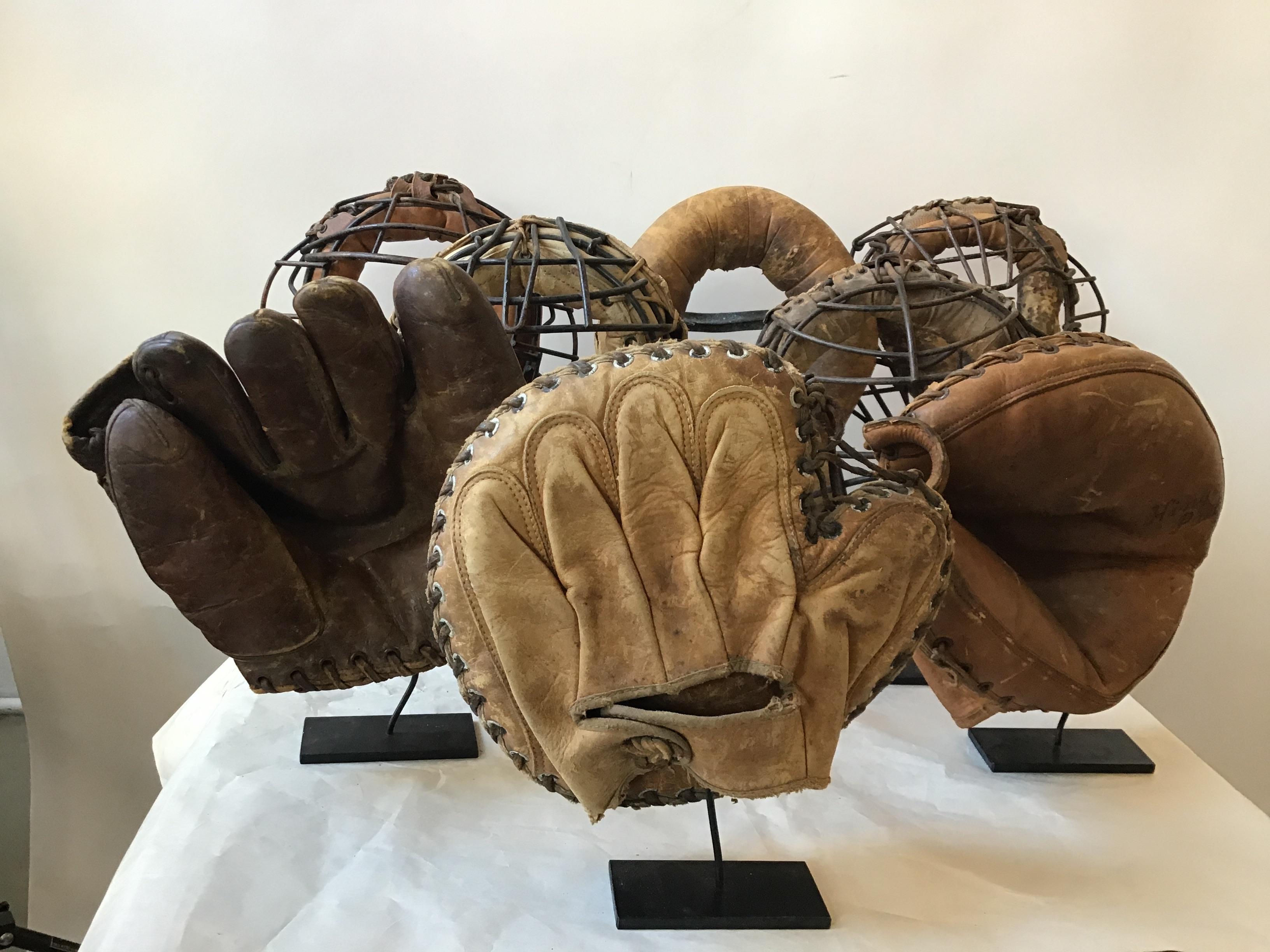 Collection of 8 1940s baseball gloves and catchers masks. Custom iron stands made for each one. Out of a EastHampton, NY estate.