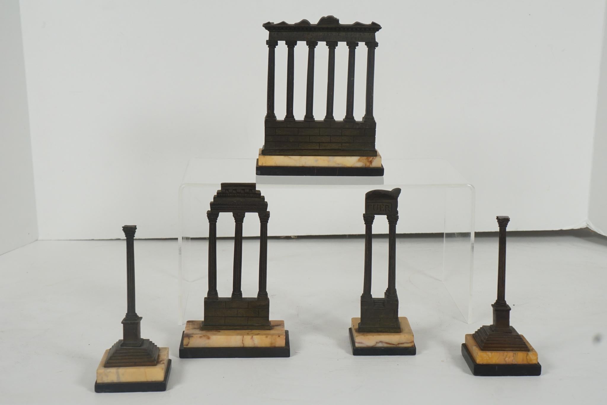 This very nice set of works represents some of the ruins in Rome from antiquity and where made in the late 19th century. 
The largest casting here is the Temple of Saturn built by Titus Larcius in 17 BC. The temple's front is composed of eight