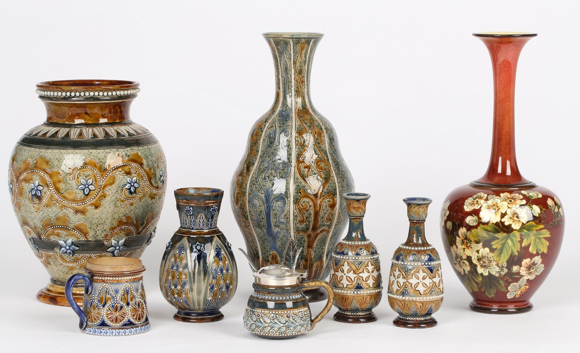 A good collection of British art pottery comprising of nine items as follows:

Thomas Smith Canal Potteries salt glazed jug with scratch design figures 1867-1894
Doulton Lambeth double gourd styled vase with floral style geometric designs by Eliza L