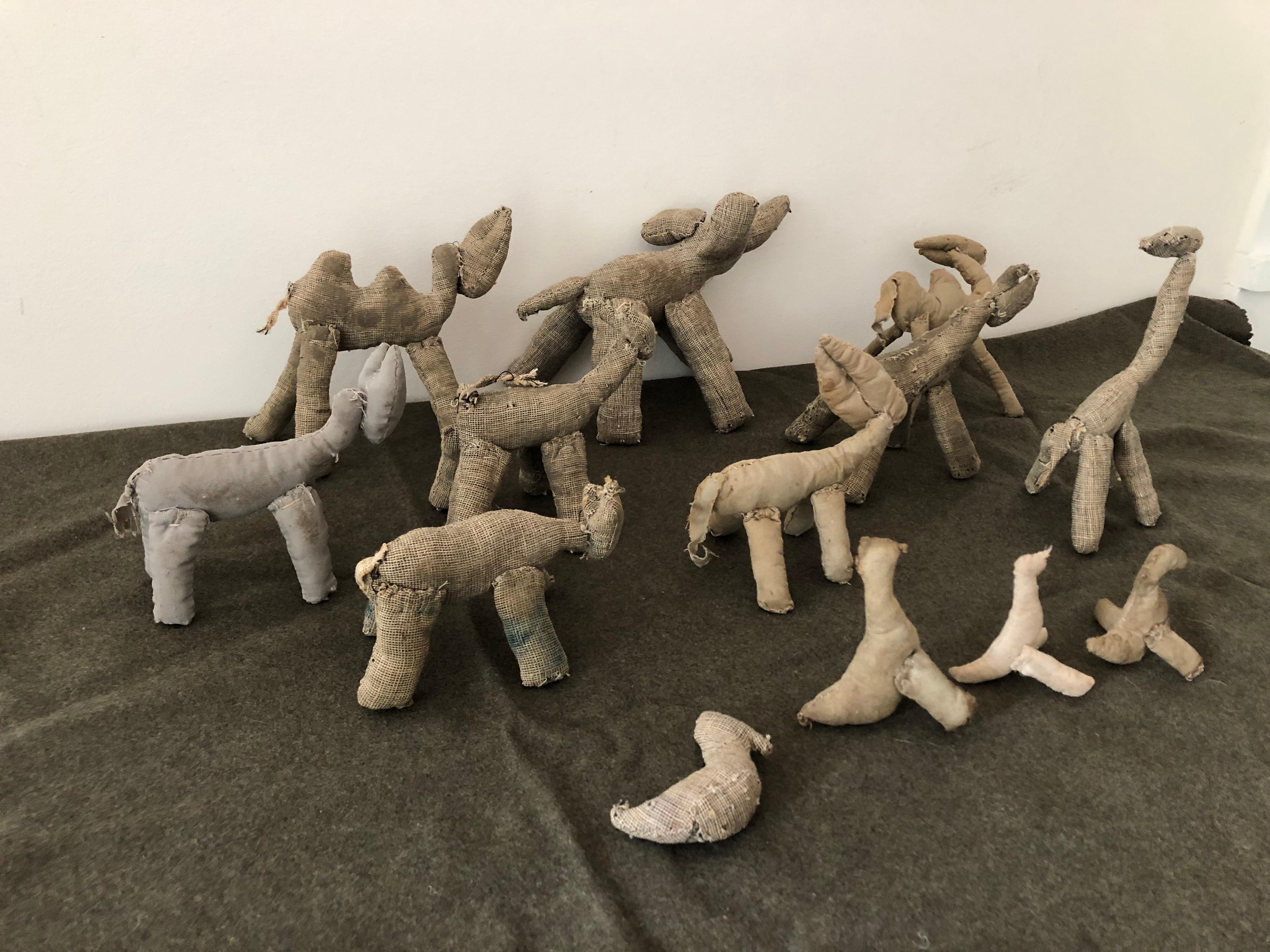 A collection of thirteen mid-19th century Amish stuffed cloth toys. Featuring various cattle, elephant, zebra, camel, ducks, and ducks. Excellent decorative piece. Largest measures 6