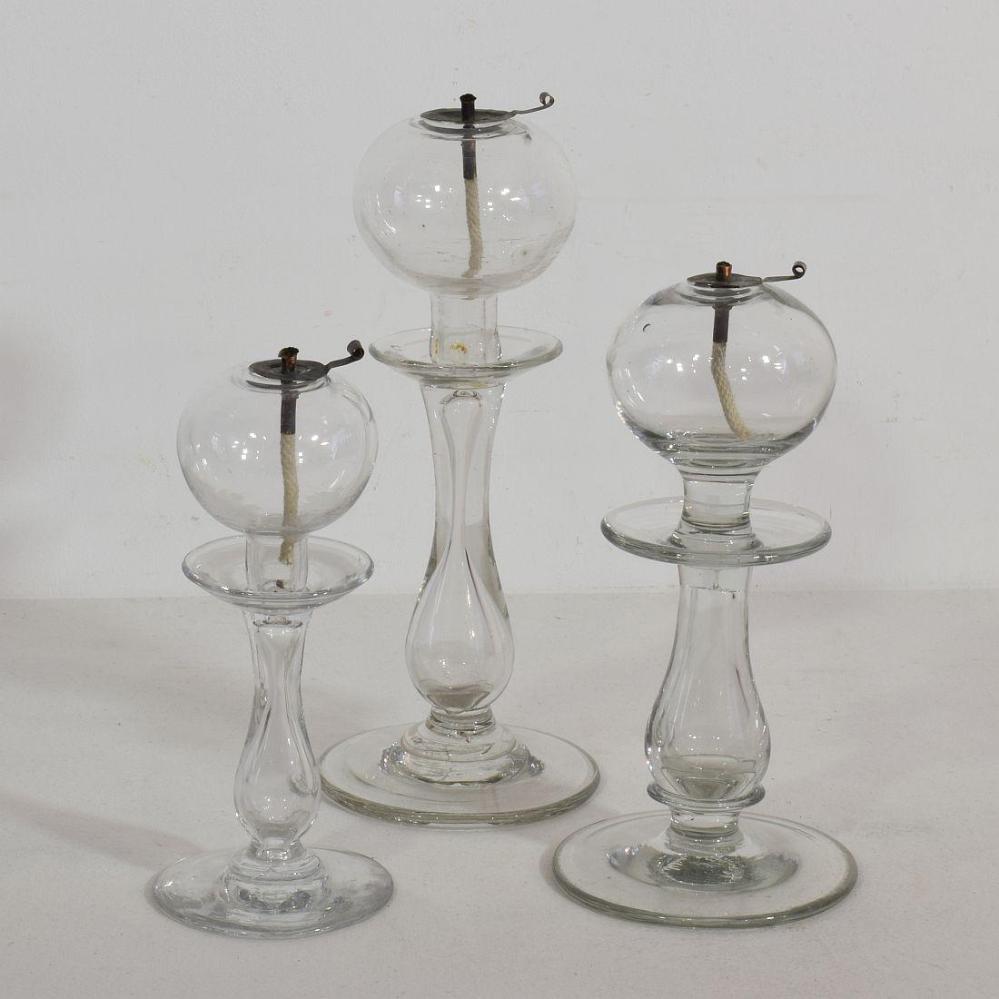 Rare collection of three hand blown glass weaver oil lamps from the South of France, France, circa 1800-1900
Very good condition.
Measures: H 19-25 cm, W 8-10.5 cm, D 8-10.5 cm each
Measurement here below is of the largest oil lamp.



