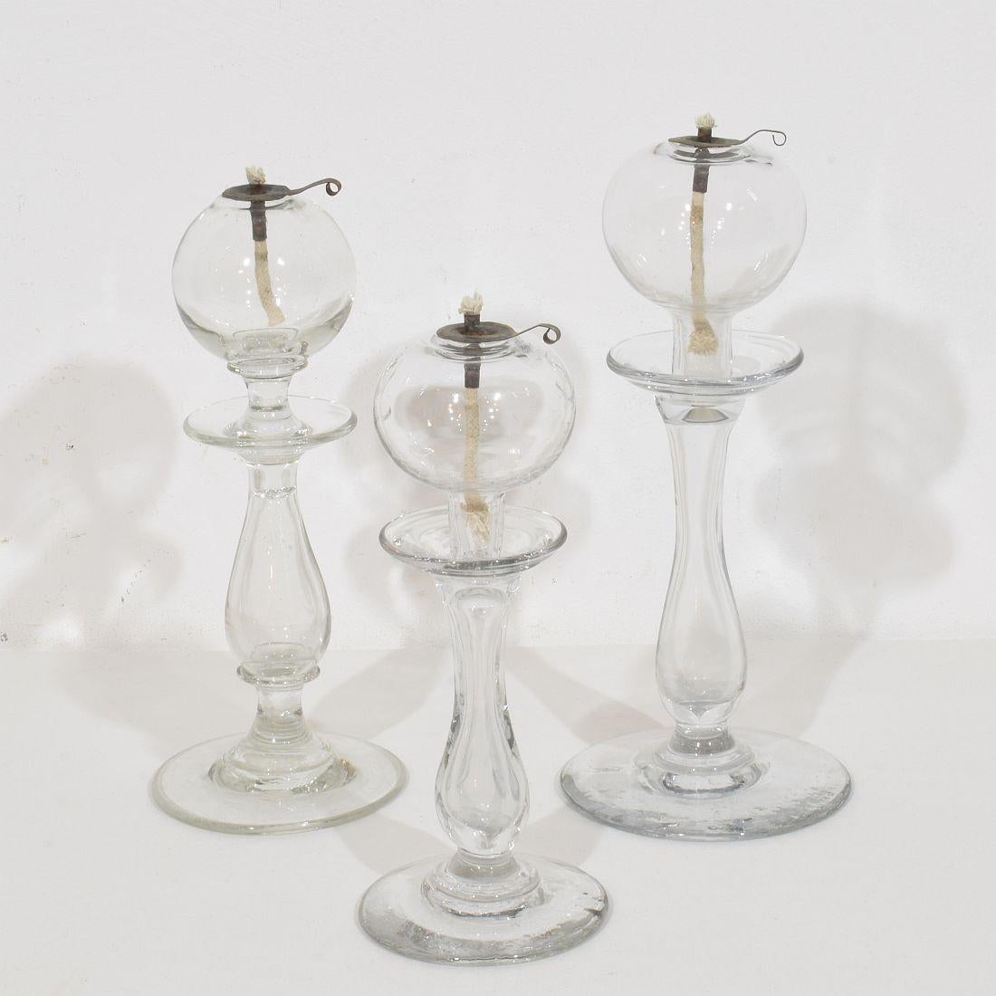 Seltene Sammlung von drei mundgeblasenen Glasweber-Öllampen aus Südfrankreich, Frankreich, um 1800-1900
Sehr guter Zustand. Dochthalter aus Kupfer neueren Datums.
Maße:H:22-26cm  W:9-11 cm  jeder.
Die nachstehende Messung zeigt die größte Öllampe.
