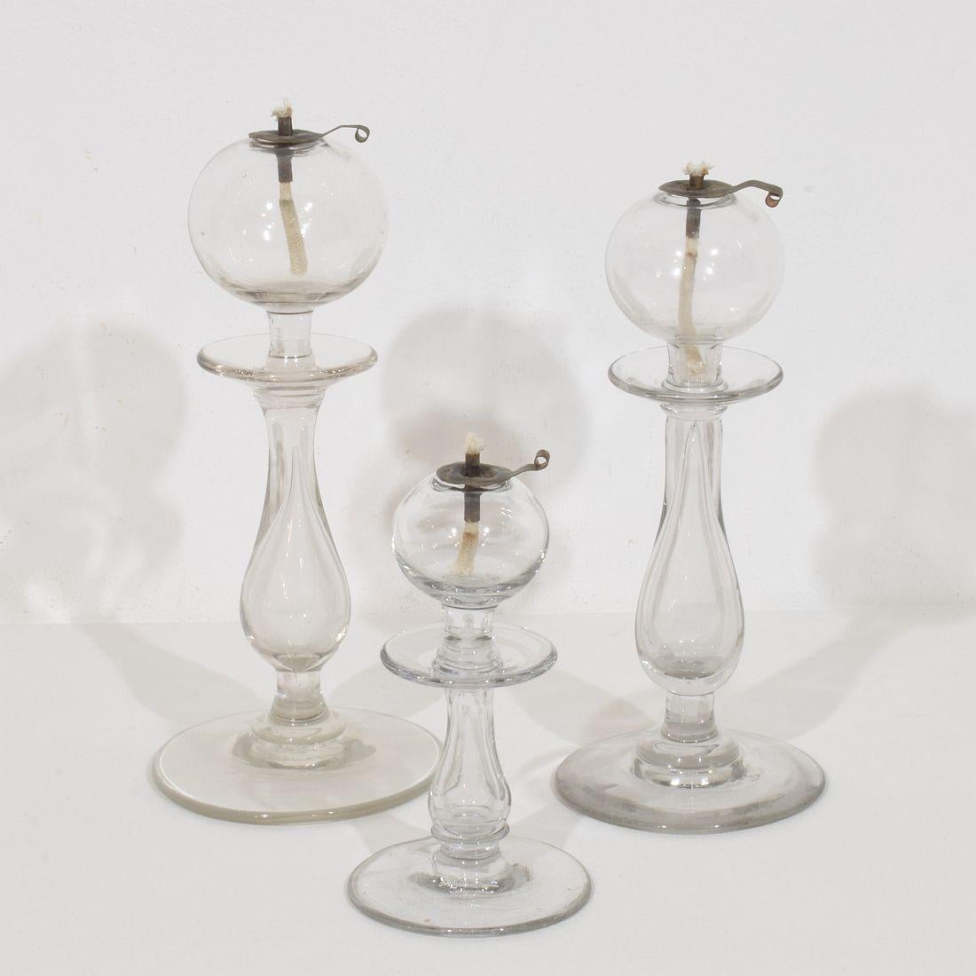 Rare collection de trois lampes à huile en verre soufflé du Sud de la France, France, vers 1800-1900
Très bon état. Porte-mèches en cuivre de date récente.
Dimensions:H:16-26cm  W:8,5-11,5cm  chacun.
La mesure ci-dessous est celle de la plus grande