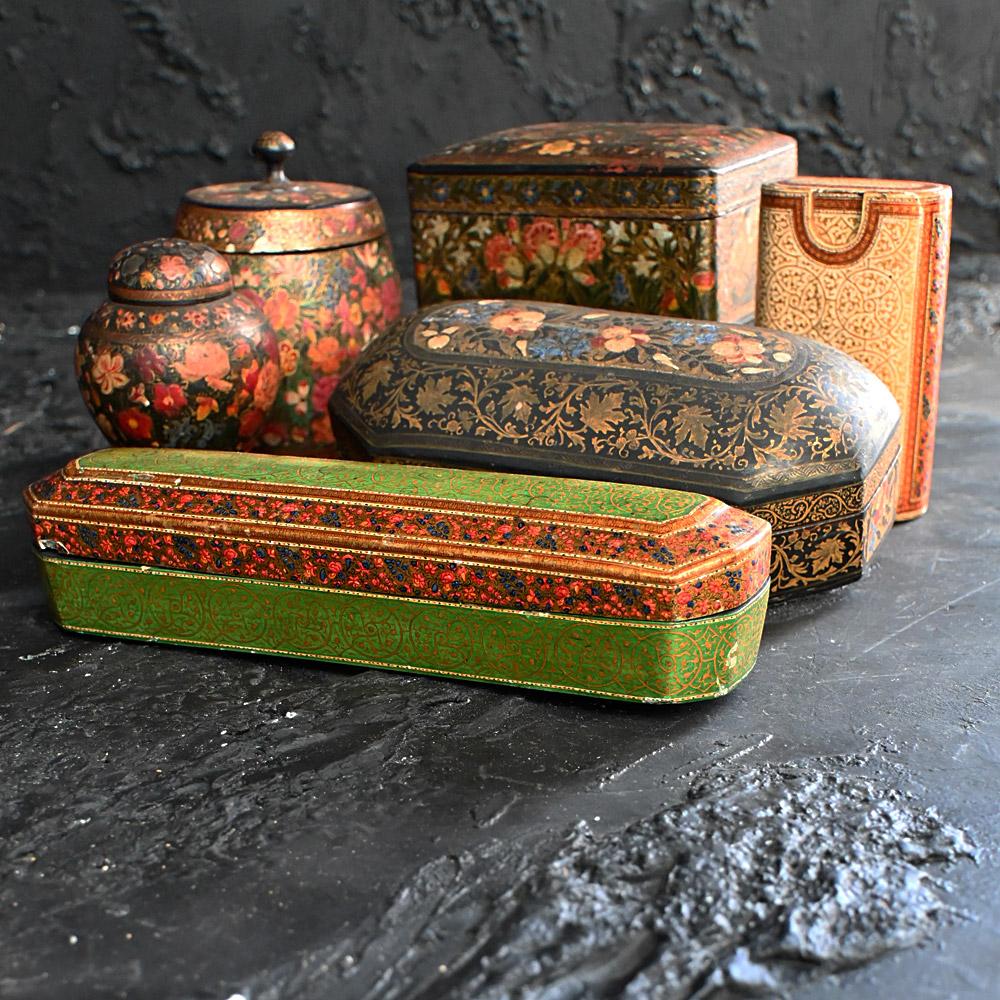 Collection of 19th Century Kashmiri Objects 
A beautiful selection of late 19th Century hand crafted Kashmiri objects. This collection includes a tobacco jar, pepper shaker, cigar box, pencil case and 2 trinket boxes. 

Kashmiri papier-mâché is a