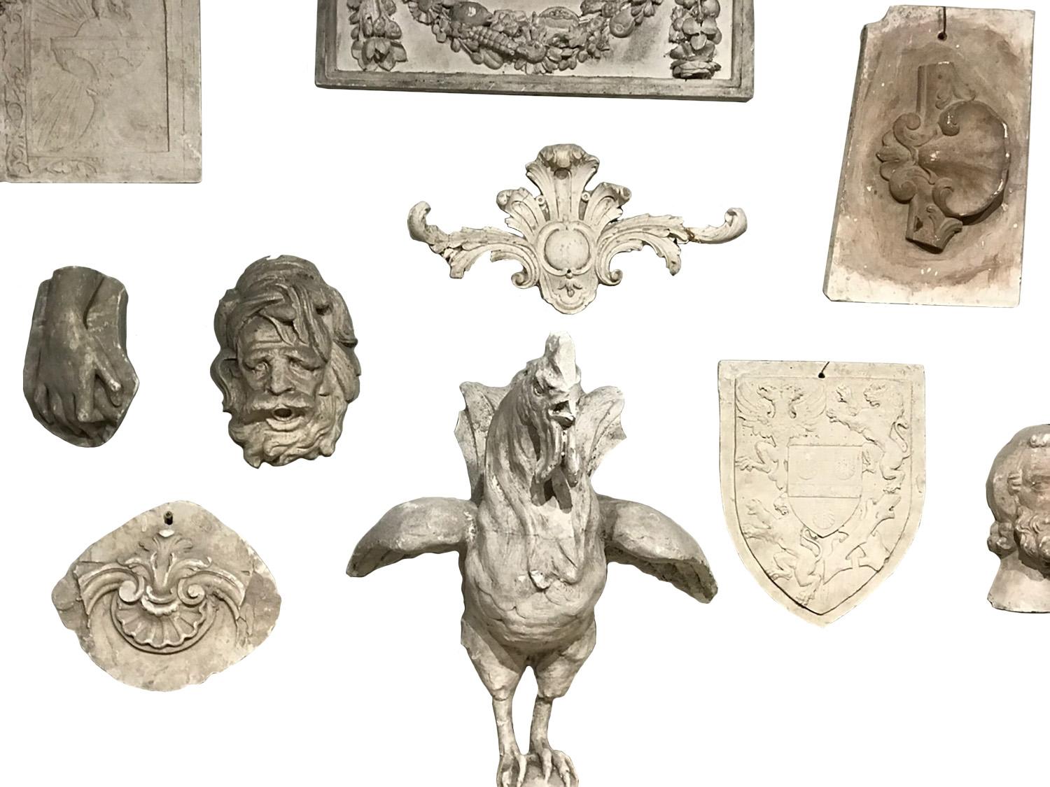 This collection of French 19th century plaster work features 22 pieces of various types, including plaques with pharmacy signs, animals and a Bacchus head. This is an extensive collection suitable for a decorating project.