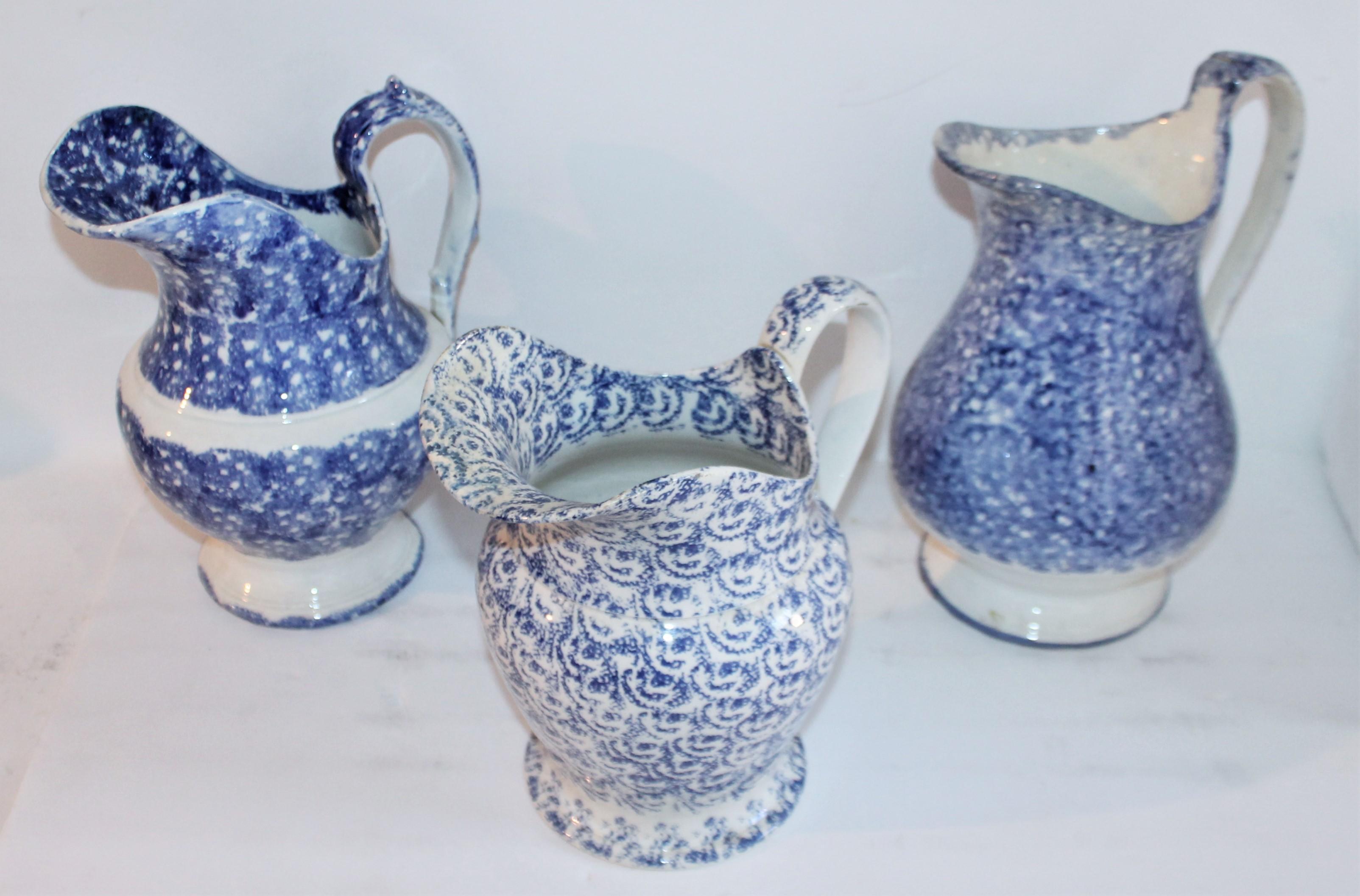 Collection of three 19th century spatter ware water pitchers in pristine condition. The shorter of the three is really quite unusual and is more of a design sponge pattern.