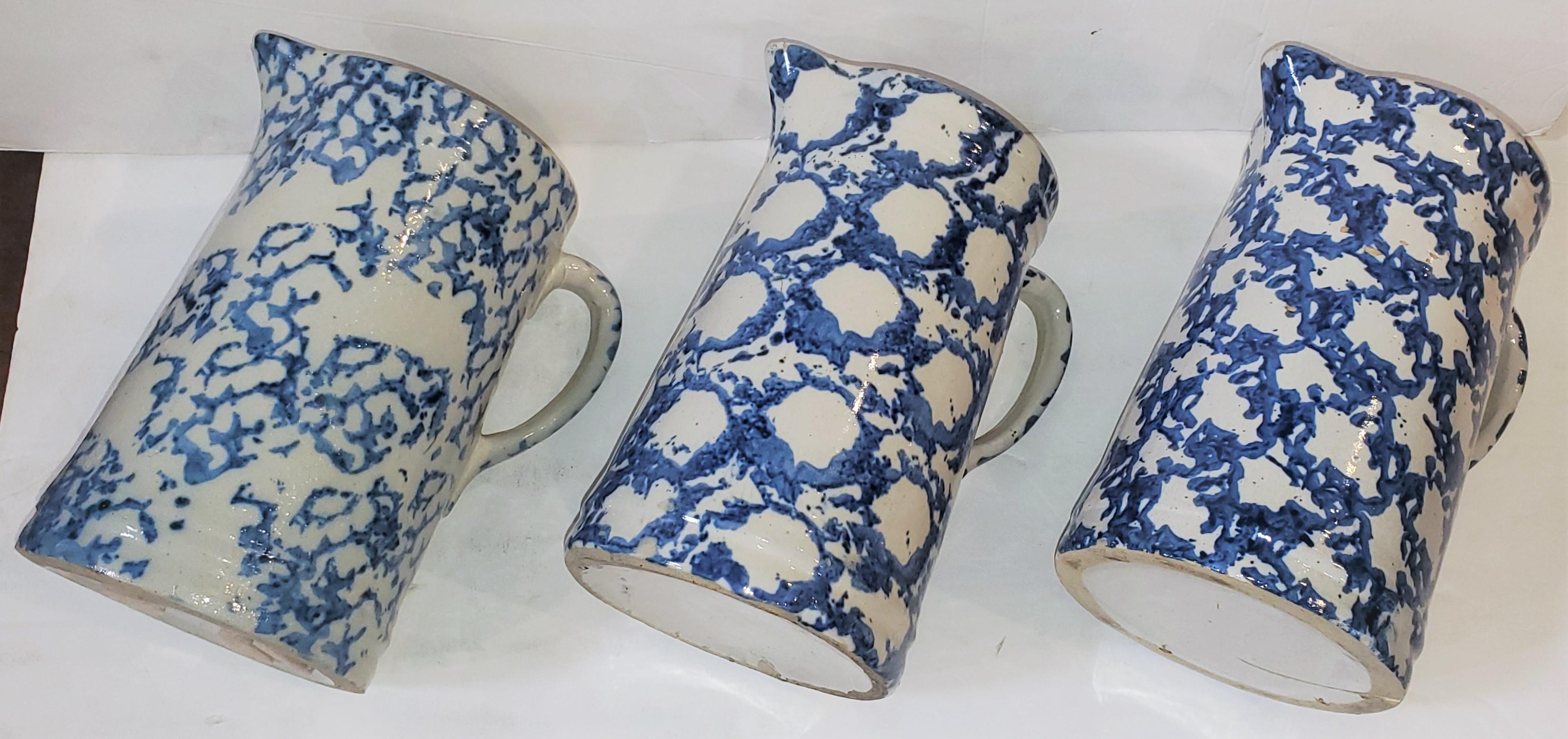 Set of three 19thc sponge ware pitchers in unusual smoke patterns. 2 smoke ring pattern pitchers. All pitchers are in pristine condition. Sold as a collection of three.