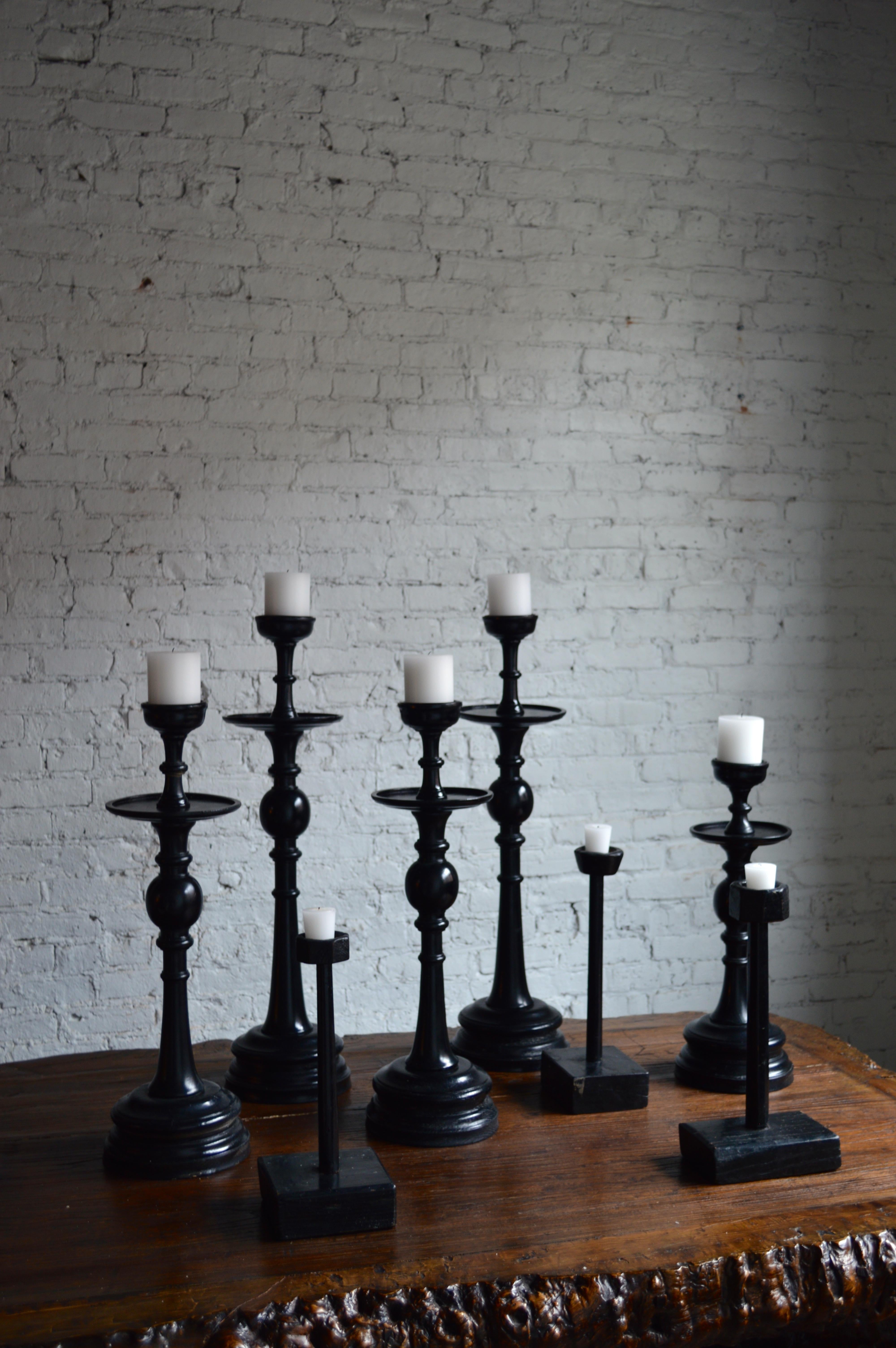 Collection of 20th century and antique Chinese set of eight wooden black lacquer candlesticks

Dimensions range from 15