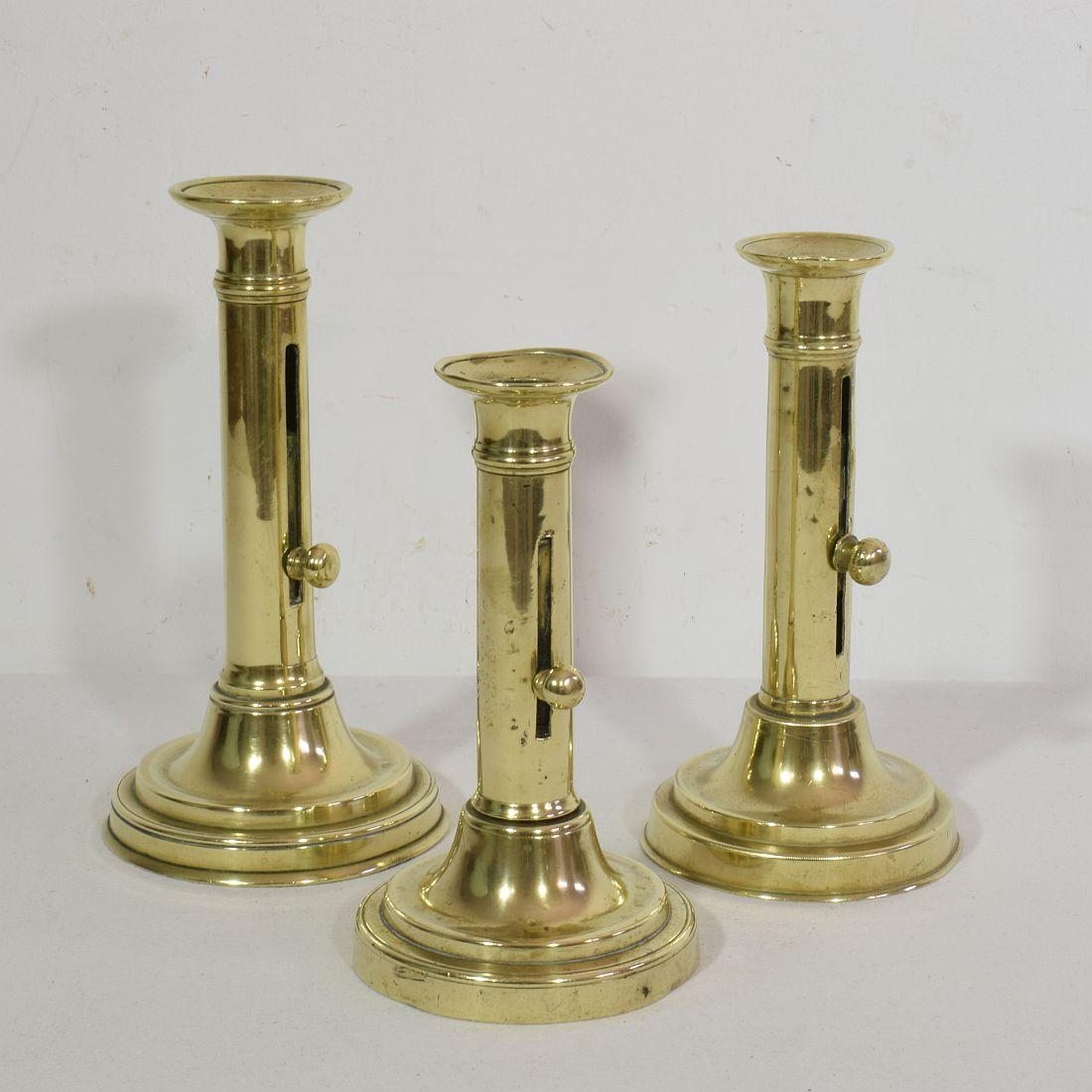 Belle Époque Collection of 3 French 19th Century Brass Bistro Push Up Candleholders For Sale