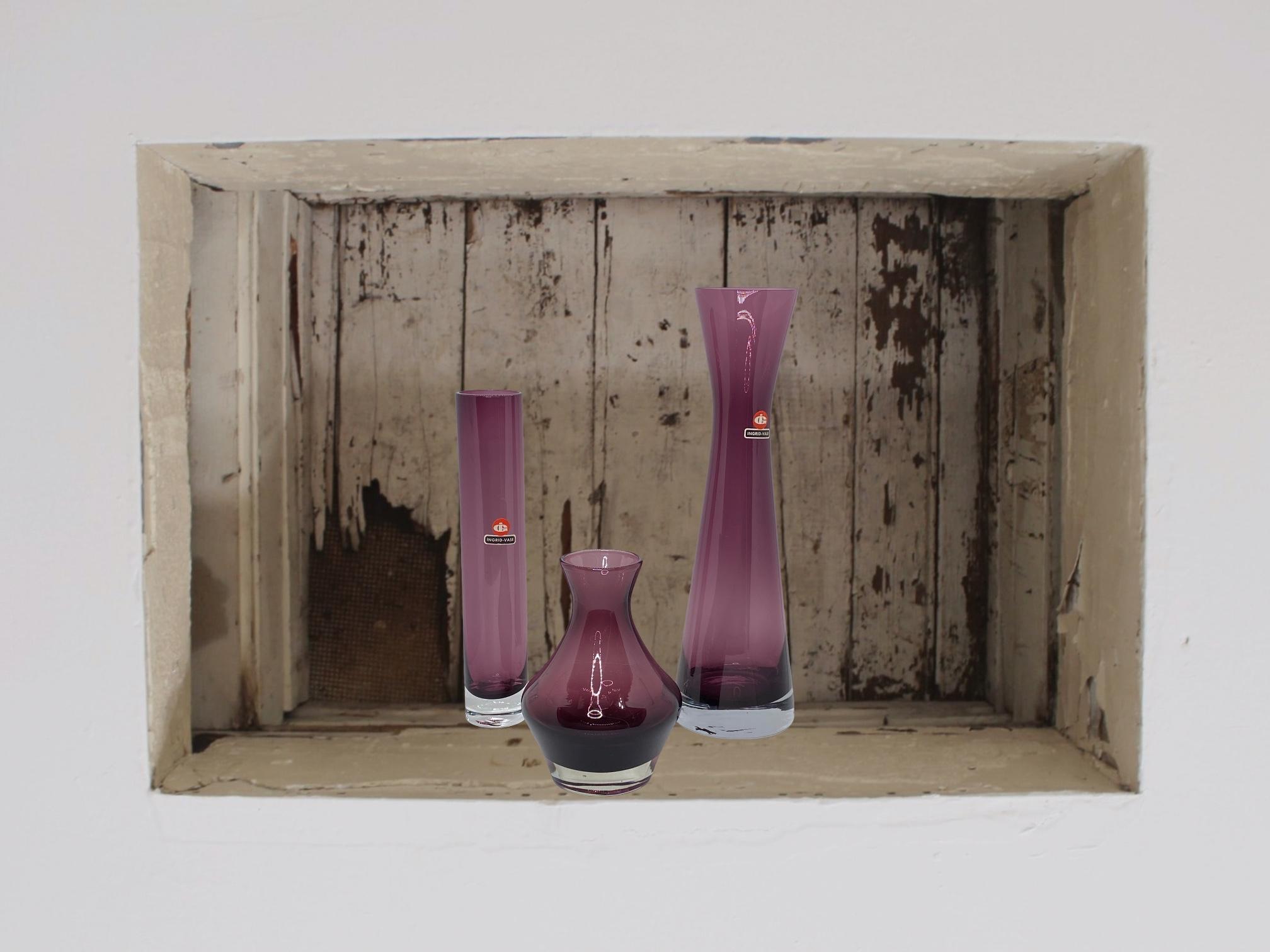 Wonderful Mid-Century Modern German vases by Ingrid Glass, circa 1970. These beautiful purple colored and clear vases bring a touch of elegance and fantasy to any room. Tallest one is approximate 11