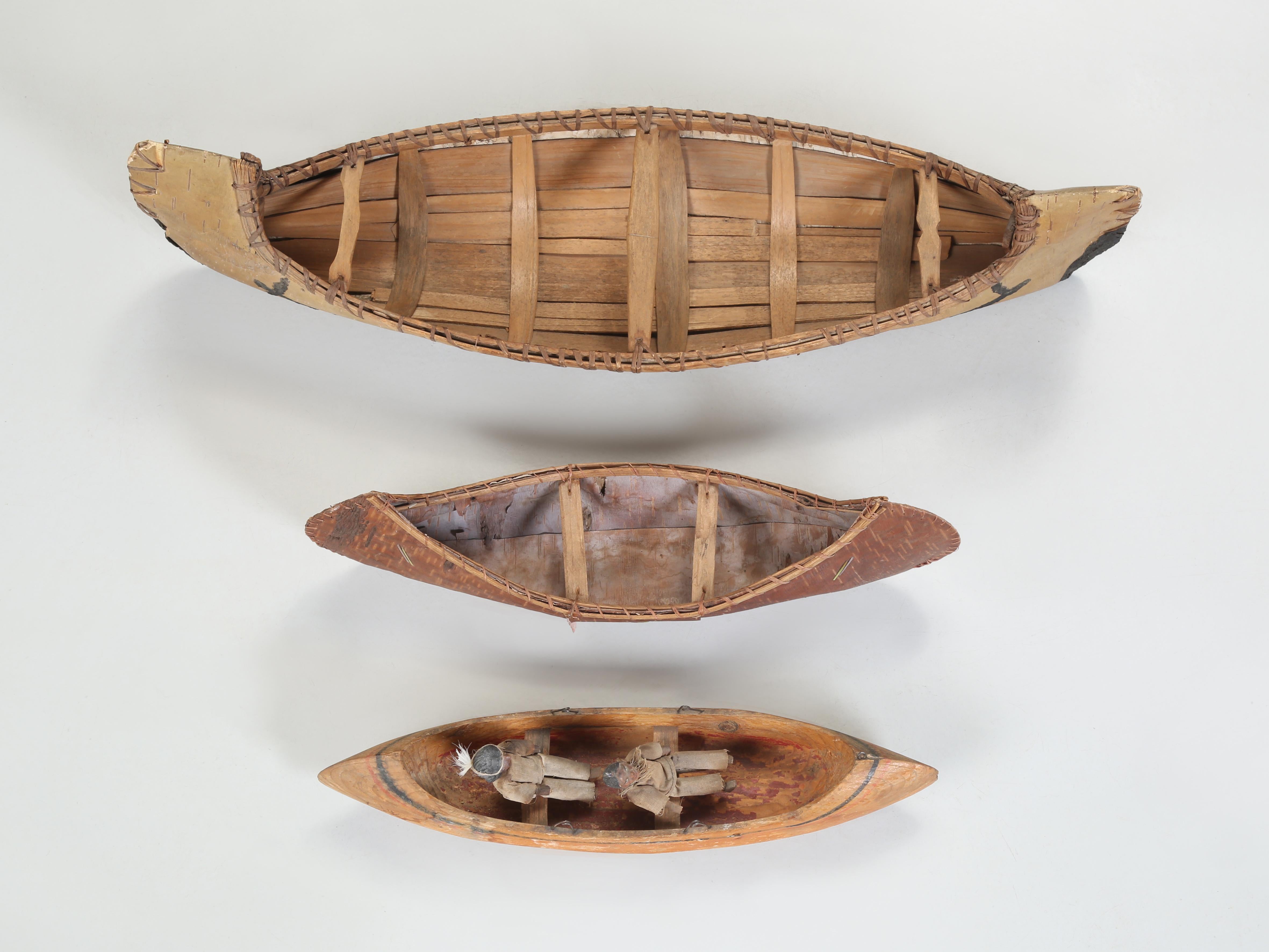 Collection of (3) Native American Folk Art Children's Toy Canoes most likely made between the 1940's and 1950's. Two of the Folk Art Children's Canoes were made from Birchbark, while the smaller third Canoe was carved from a piece of wood and has