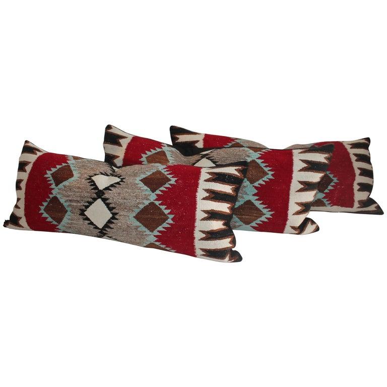 Navajo Indian weaving bolster pillow with black linen cotton backing. These amazing geometric Indian weaving contains turquoise, red and brown, black and cream. So unusual pattern and colors. 

These Sell individually for $795.