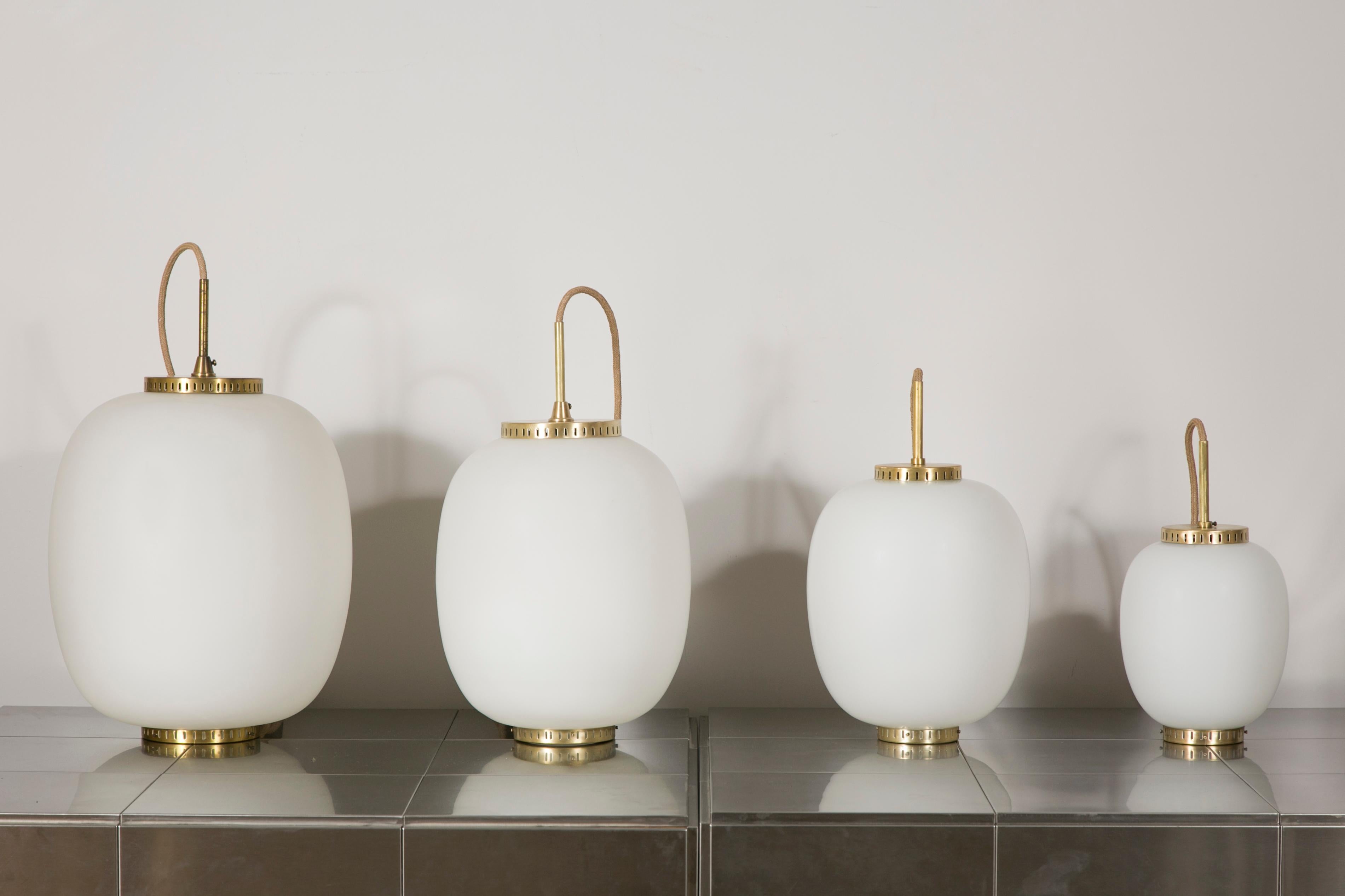 Collection of 3 opaline glass and brass ceiling fixtures.
See dimensions below 
By Bent Karlby for Lyfa. 
Denmark, late 1950s.

Various dimensions available: (Height of the opaline and brass disc) 
Medium (two items available): H 11.8 in. (30
