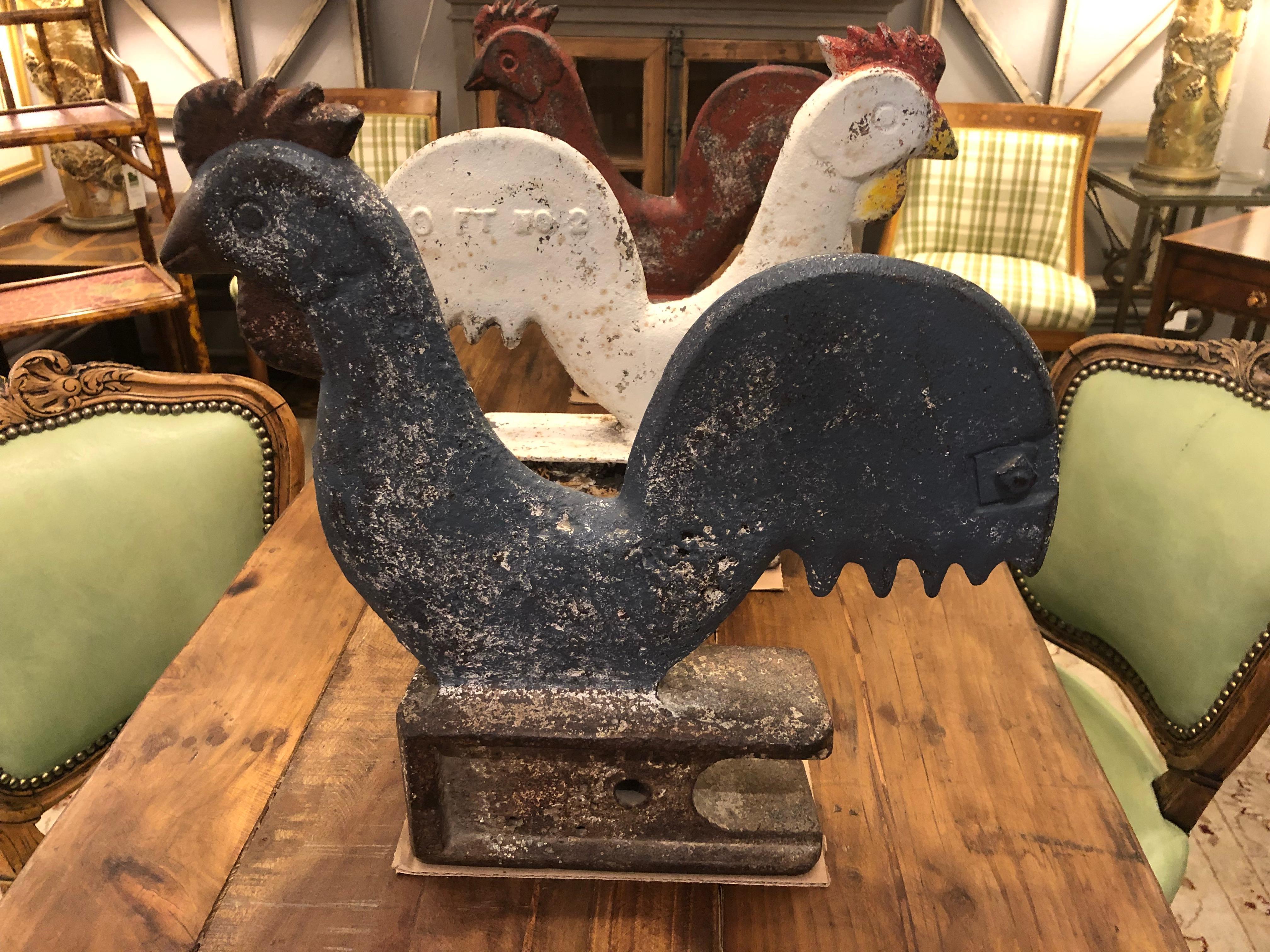 Very rare and fantastic found object trio of iron vintage cast iron windmill weights with Folk Art rooster charm. Original use was for a 10 foot wheel and used as a counter balance on the windmill as a weight. Original paint with a fabulous grouping