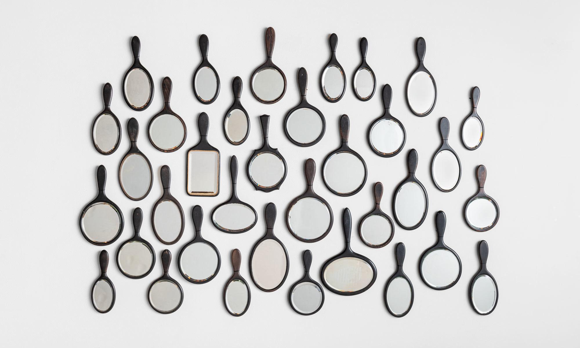 Collection of (35) black hand mirrors, England circa 1880.

An assortment of small forms with slight variations in size and shape.
