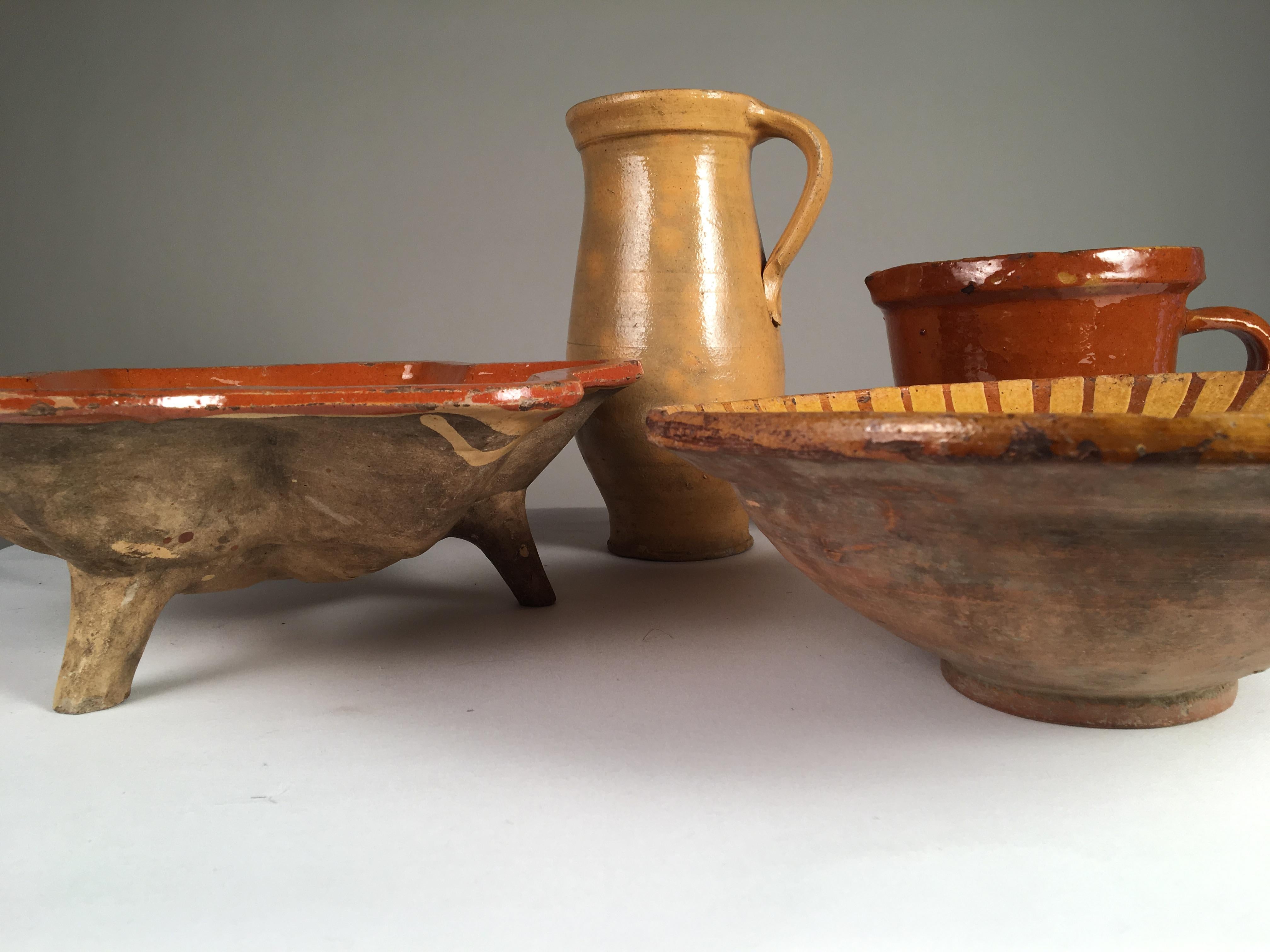 Collection of 4 French pottery items, 19th century, including a footed bowl, a decorated bowl, a tall tankard, and a measure.