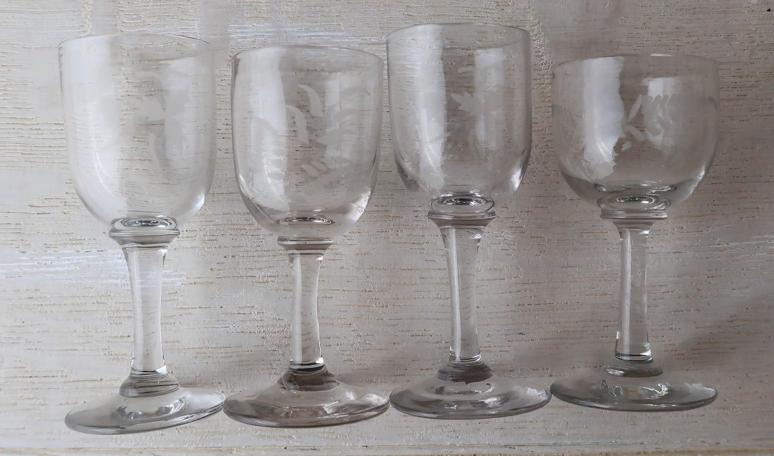 Nice collection of 4 glasses. All slightly different

Rather primitive with quite crude etching of ferns and other leaves

Polished pontil marks

The measurement relates to the largest of the four



Silver plated tray not included.