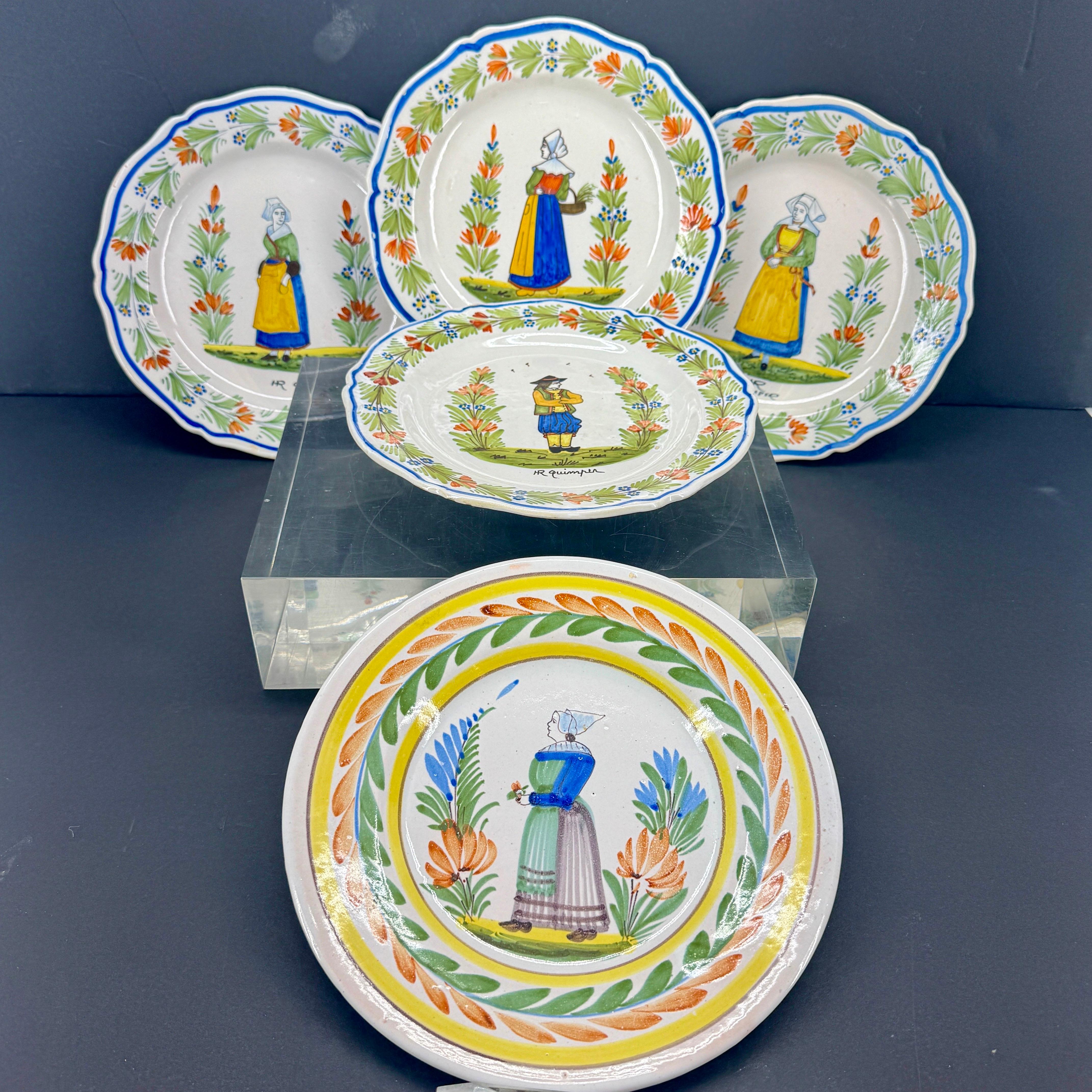 Wonderful collection of French Quimper plates. This collection has been curated over the years and would make a fantastic colorful statement piece on any coffee table or dining room sideboard stacked up. Add to an existing collection or start a new