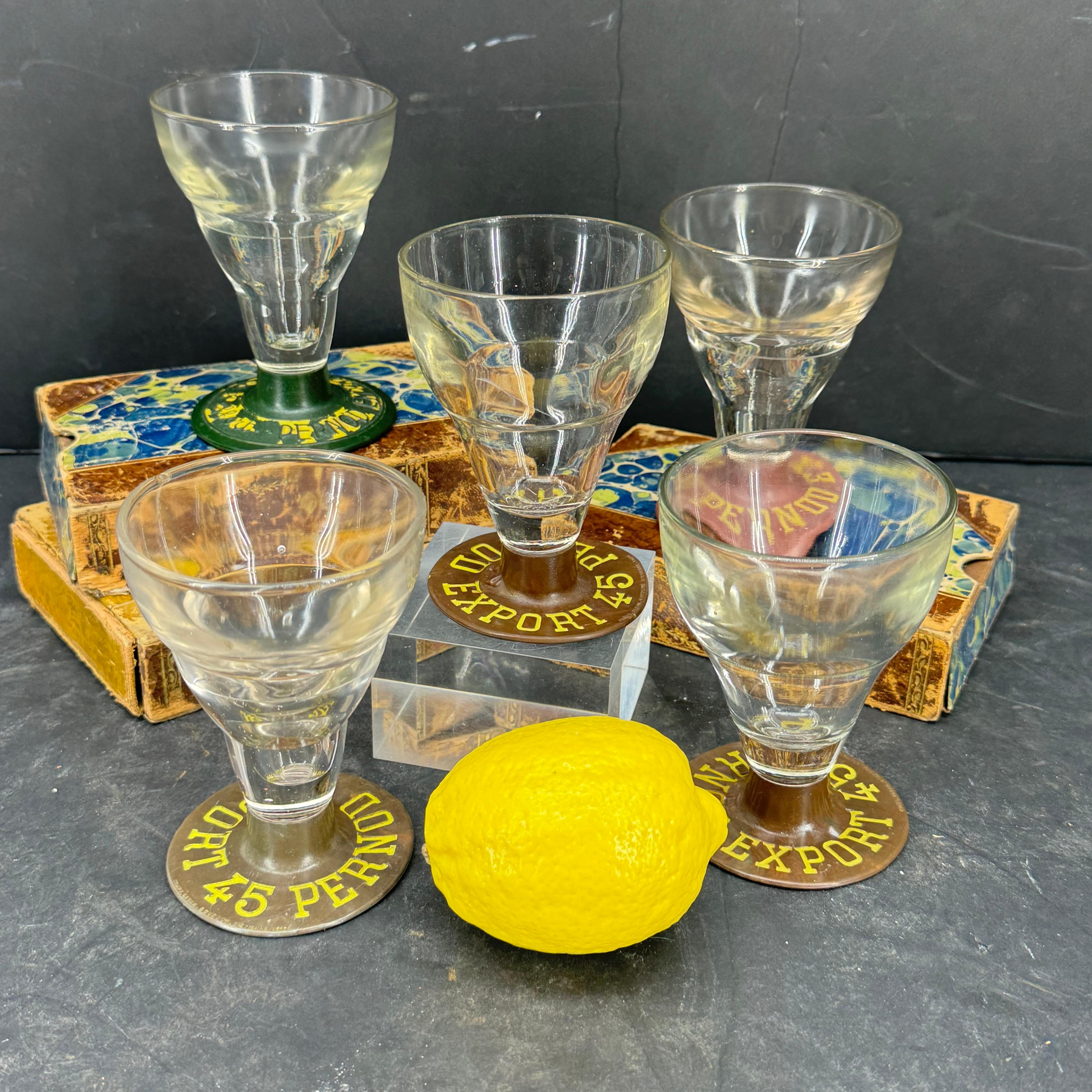 Collection of 5 French pre-world war Pernod drinking glasses with bakelite bases. The glass screws onto the Bakelite base, in order keep the foot and screw a new glass on when the glass brakes. Great pieces to add to an existing bar of these classic