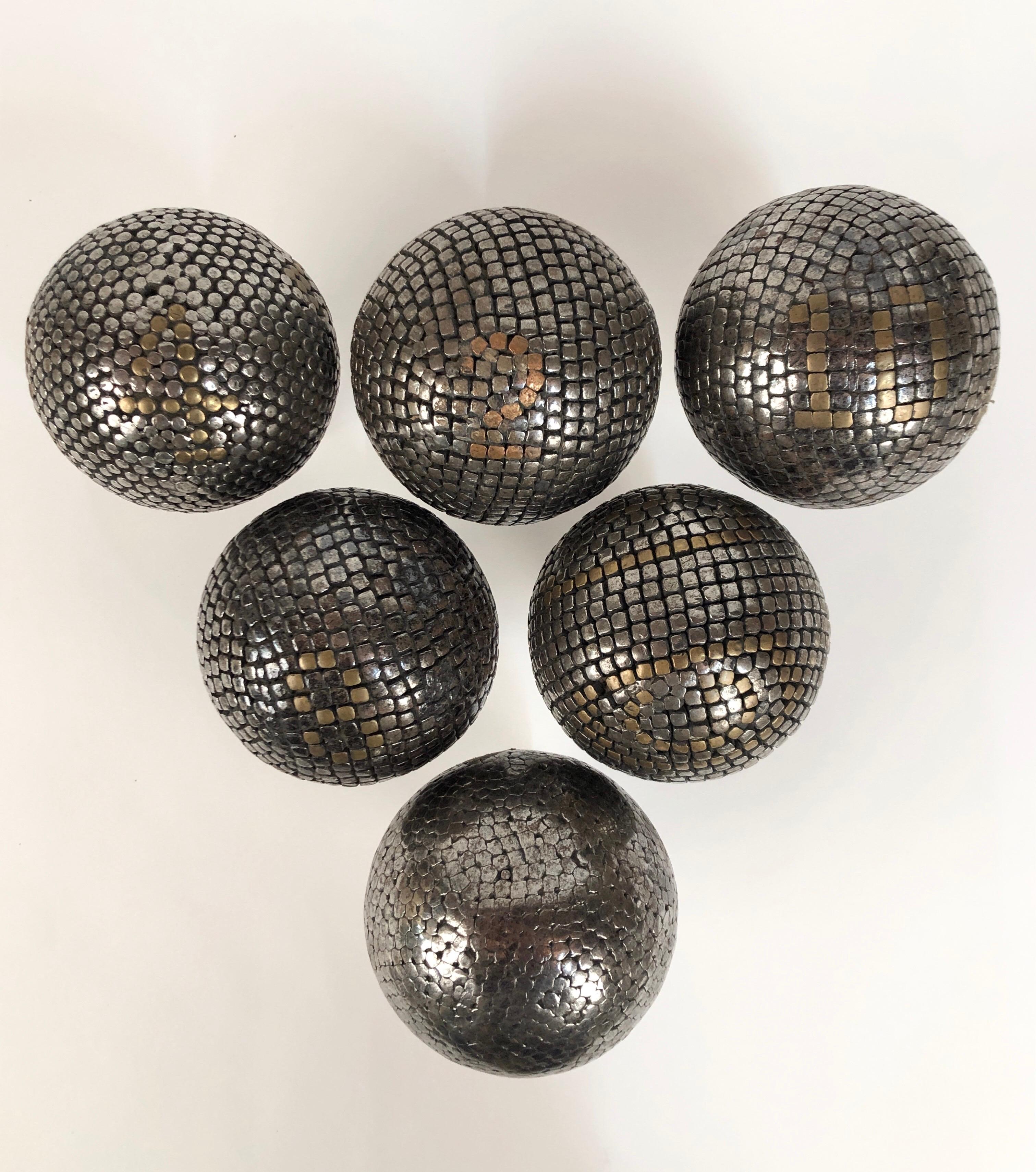 A collection of 6 antique steel and brass studded petanque balls. Used in a game similar to bocce. All six come with Lucite stands. Most with brass inlaid numbers.