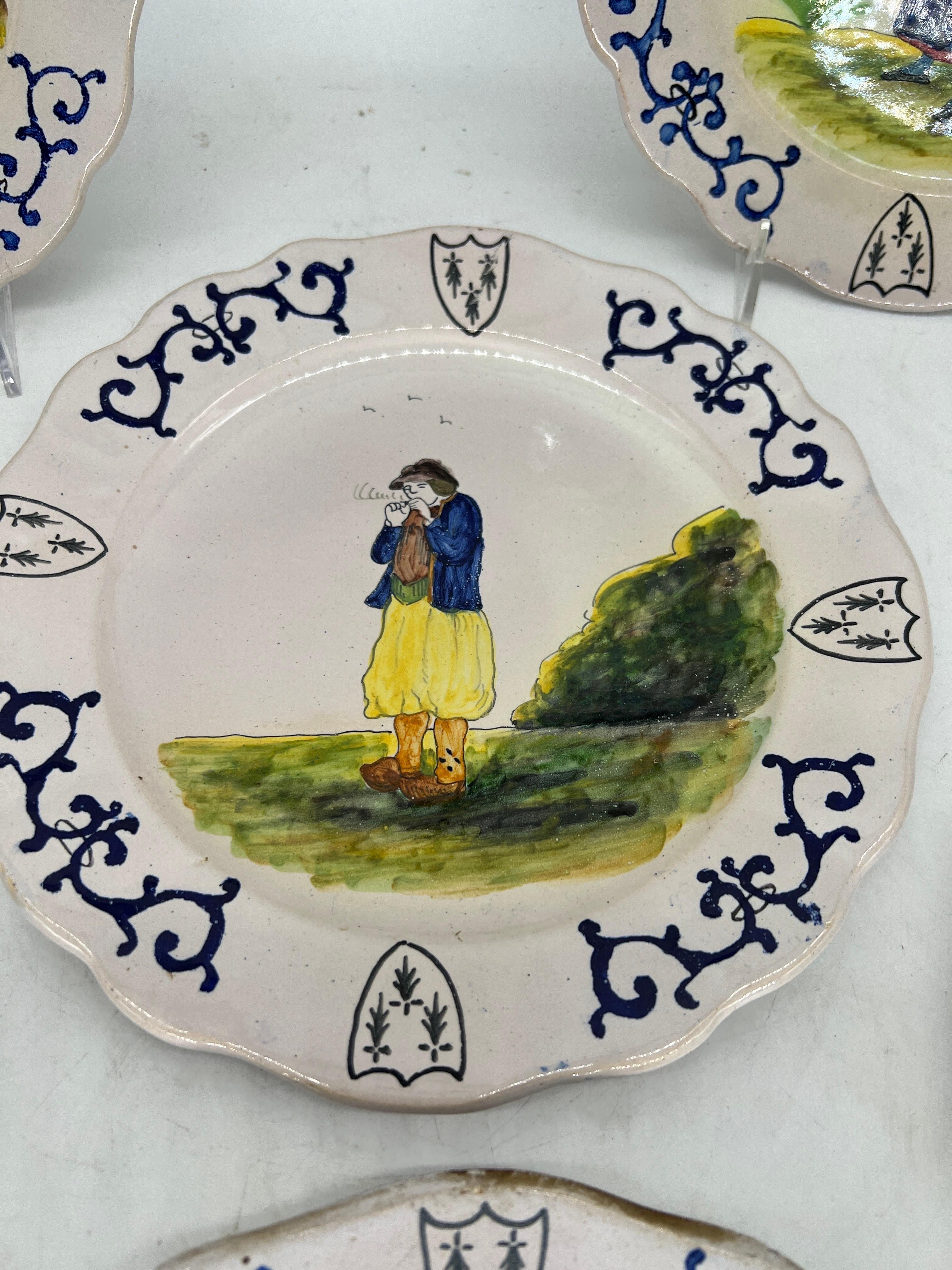 Collection of 6 French Quimper Faience Pottery Figural Shield Armorial Plates In Good Condition For Sale In Atlanta, GA