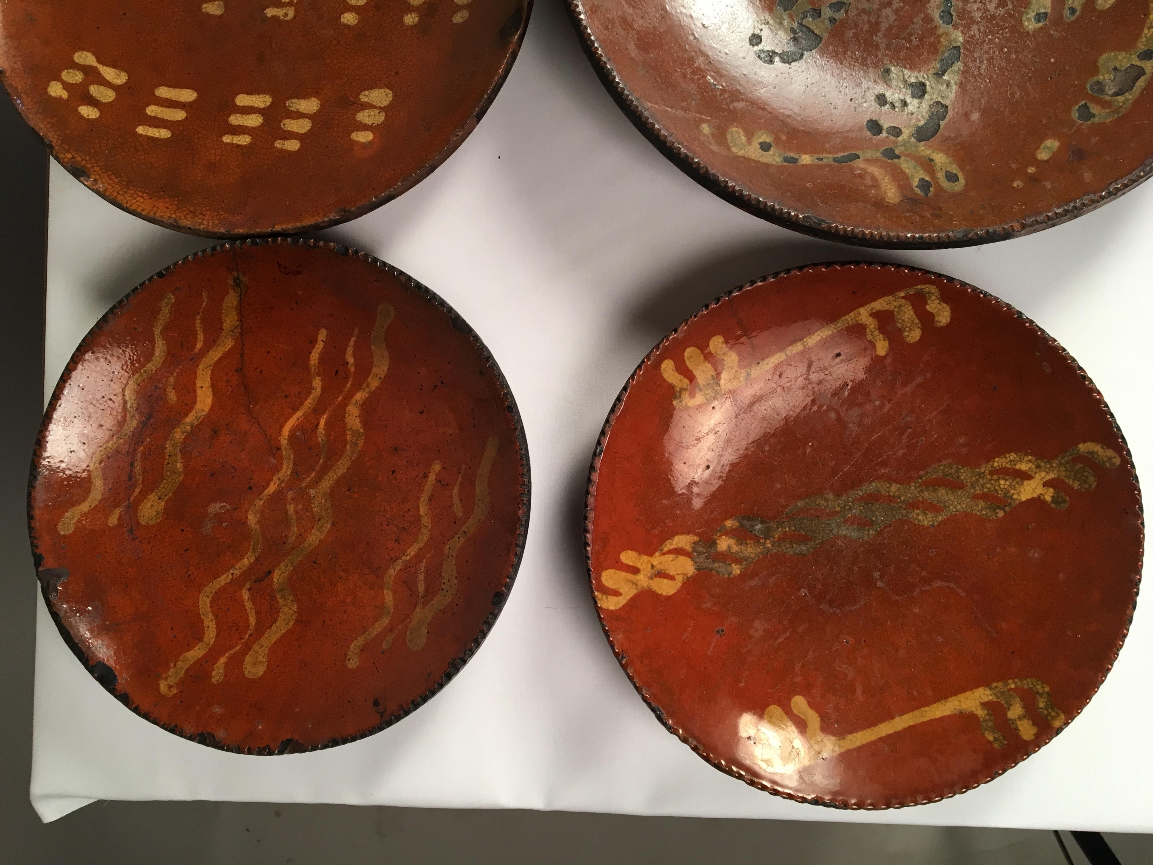 A collection of 6 Pennsylvania redware plates, late 18th century-early 19th century.