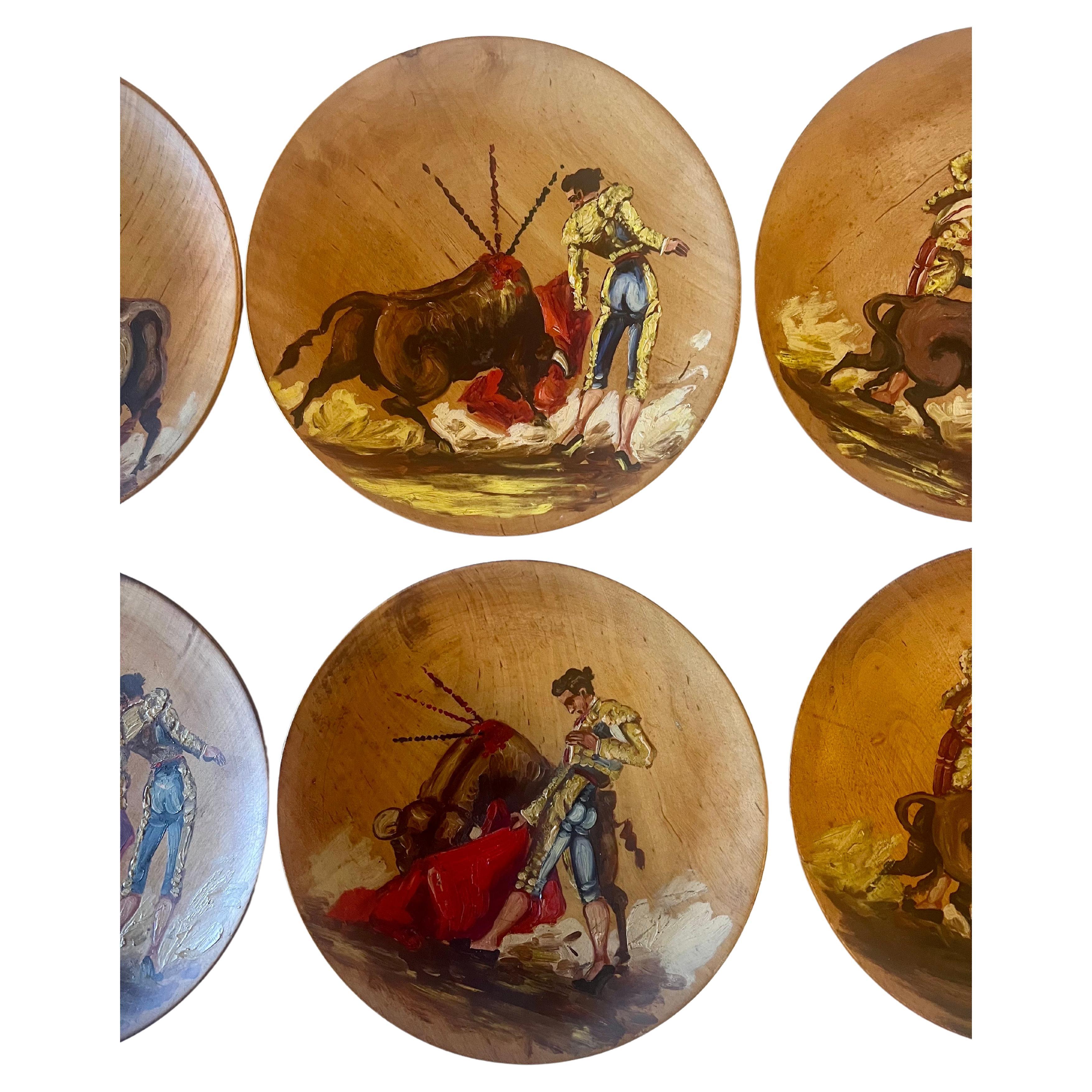 A set of 6 unique hand-painted wood plates depicting a bullfight brought from Spain in the 1950's nice original patina and beautiful hand work, on solid maple decorative plated easy to hang.