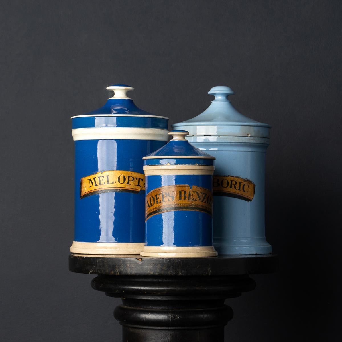 Antique ceramic chemists storage canisters
Two darker blue and white ceramic jars and one paler blue example, all with their lids and original gilt labels.

They all have some cosmetic wear and damage commensurate with age and use but are all