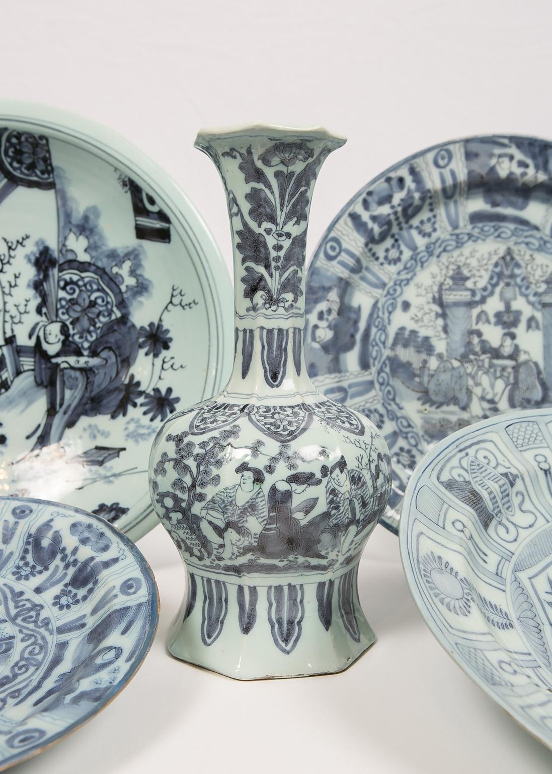 We are pleased to offer this collection of antique Delft with chinoiserie decoration. It has the light cobalt coloring typical of late 17th and very early 18th century Dutch ceramics. On each of these five pieces Delft craftsmen wove Dutch technique