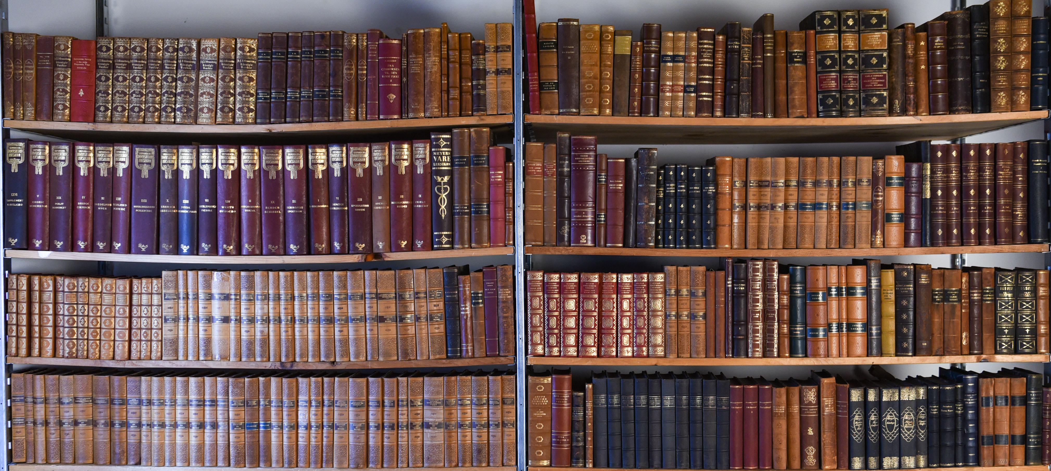 Start your own library with this incredible large collection of Danish antique leather bound books. These would be a fantastic way to decorate a library room. All are in Danish. Approximately ten boxes full of books of various sizes and colors.