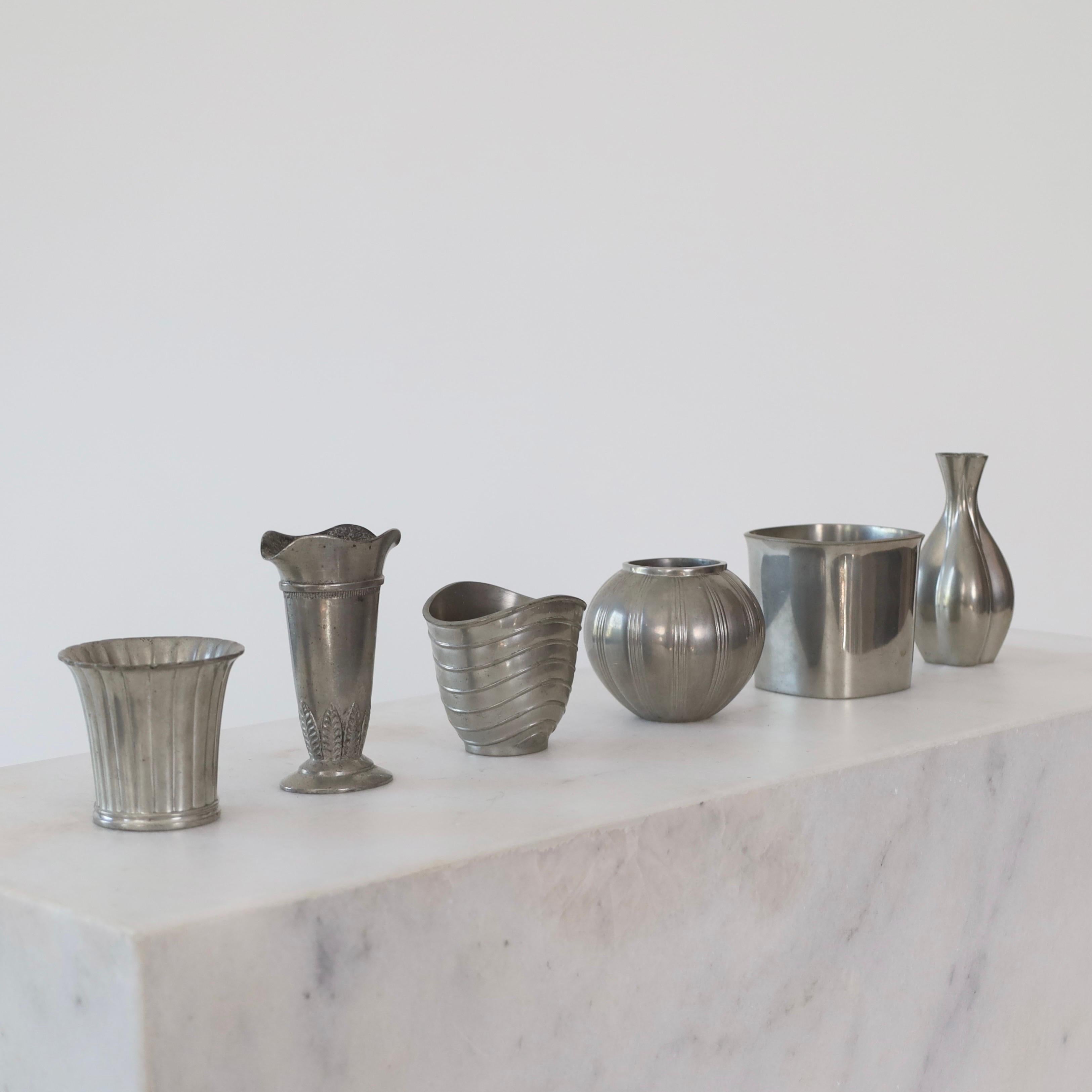 A collection of small art deco Pewter vases made by Just Andersen between the early 1920s and through 1940s. A fine collection for a beautiful place.

* A collection of six (6) different small pewter vases
* Designer: Just Andersen (5 out of 6)
*