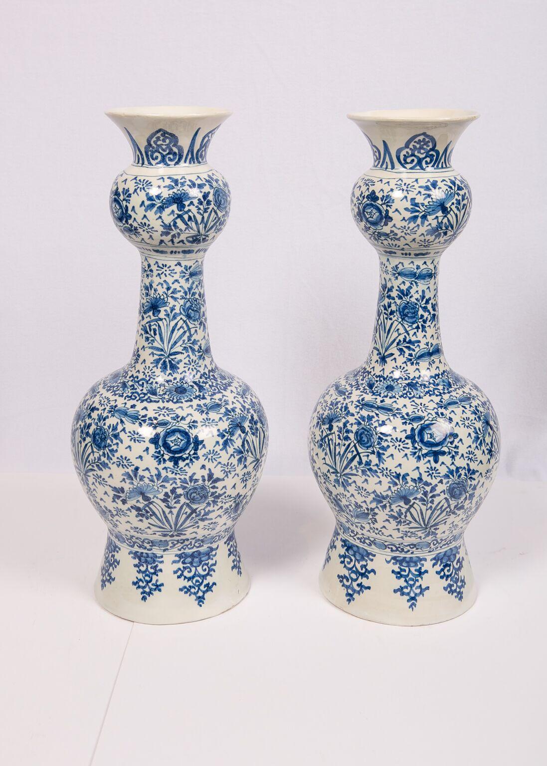 We are pleased to offer this beautiful group of 18th century blue and white Dutch delft hand painted vases for your home. At the back of the group is a beautiful pair of tall gourd-shaped vases hand painted in the 