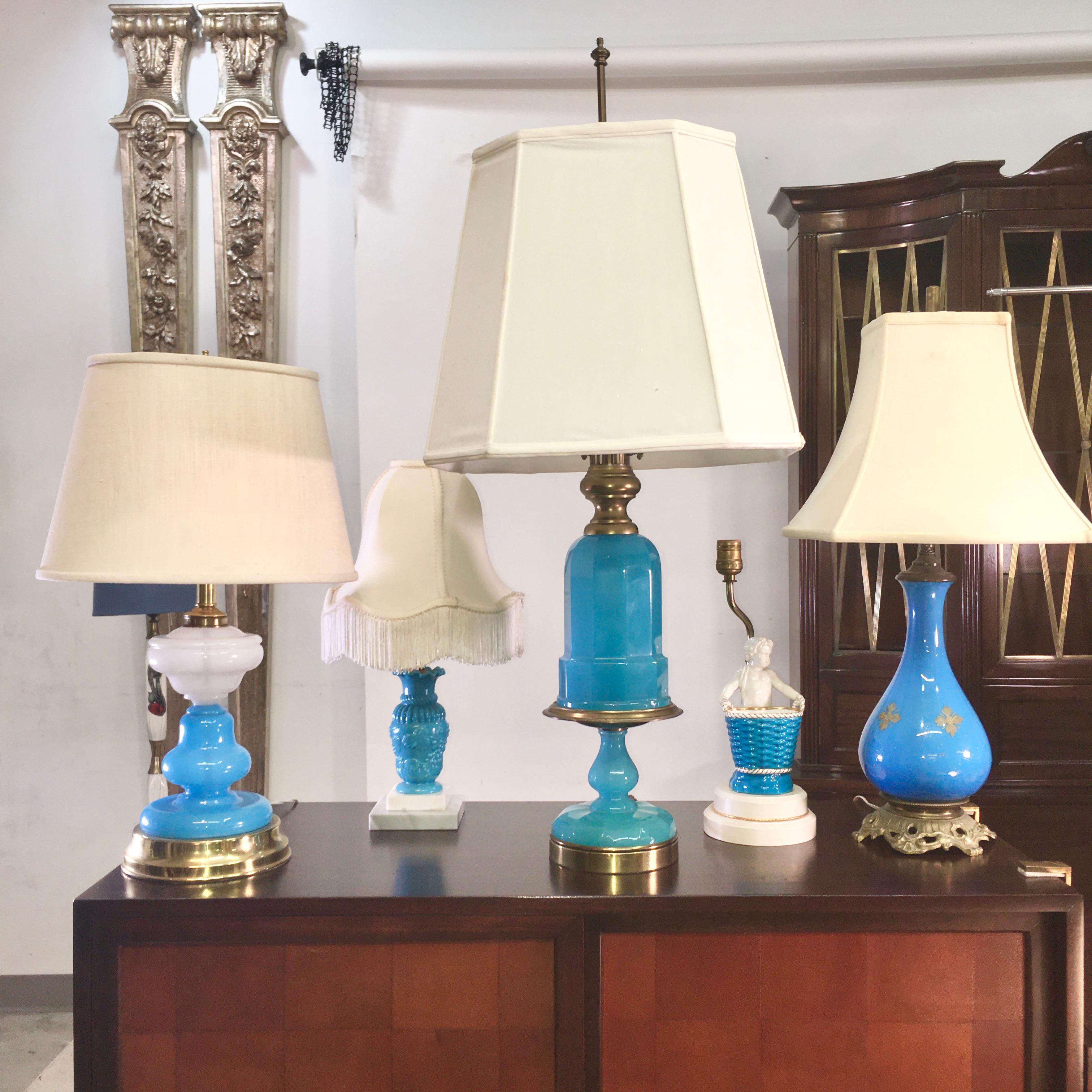 Unique grouping of five lamps from the mid-20th century in complementary shades of blue, the largest of which is a turquoise blue opaline Cenedese glass lamp mounted on gilt brass.
All of these are from the estate of Sarasota artist Miriam Shorr.