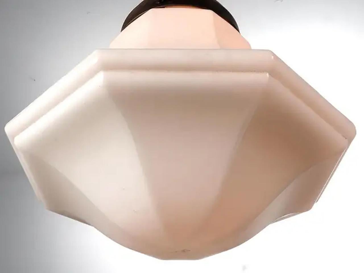 These are nice classic pendents. The shape is a closed bell in an octagon. The look is elegant and up scale. Its milk glass with a unique egg shell finish. It still uses the original shade holders. They are priced and sold per fixture.