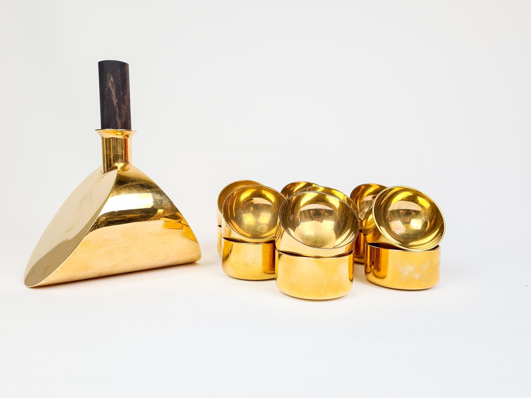 Wonderful, sculptured brass Decanter and bowls made from solid brass. These ones were manufactured in Sweden at Skultuna and Designed by Pierre Forssell. There are one decanter and 14 small bowls suited for shots or just as decorative