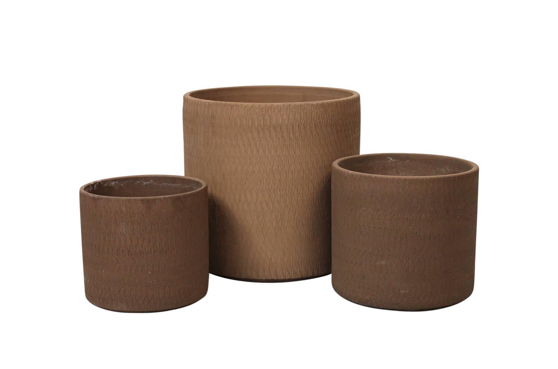Trio of large architectural pottery planters by Gainey. Thick walled pots with a carved striated or 