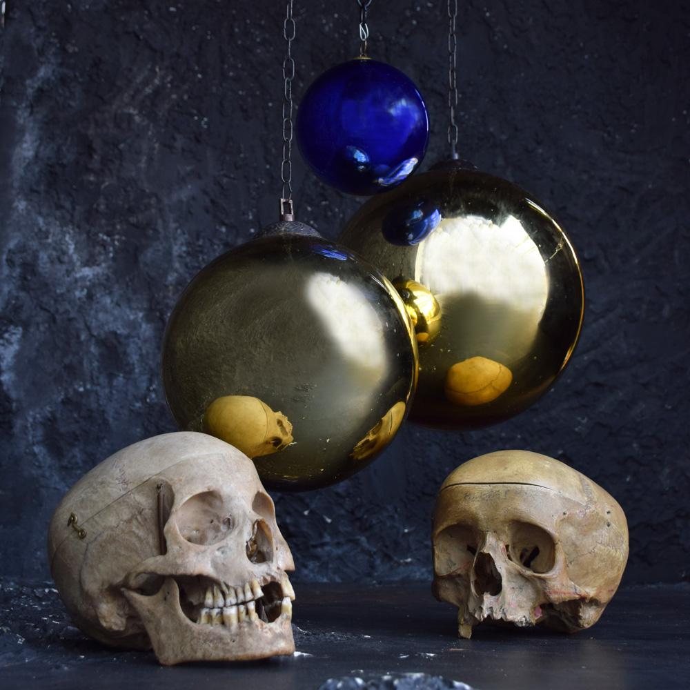 Collection of early 20th century mercury glass witches’ balls
We are proud to offer a collection of 3 early 20th century mercury glass witches’ balls. In various sizes and gold and cobalt blue, all attached to their original brass handing galleries