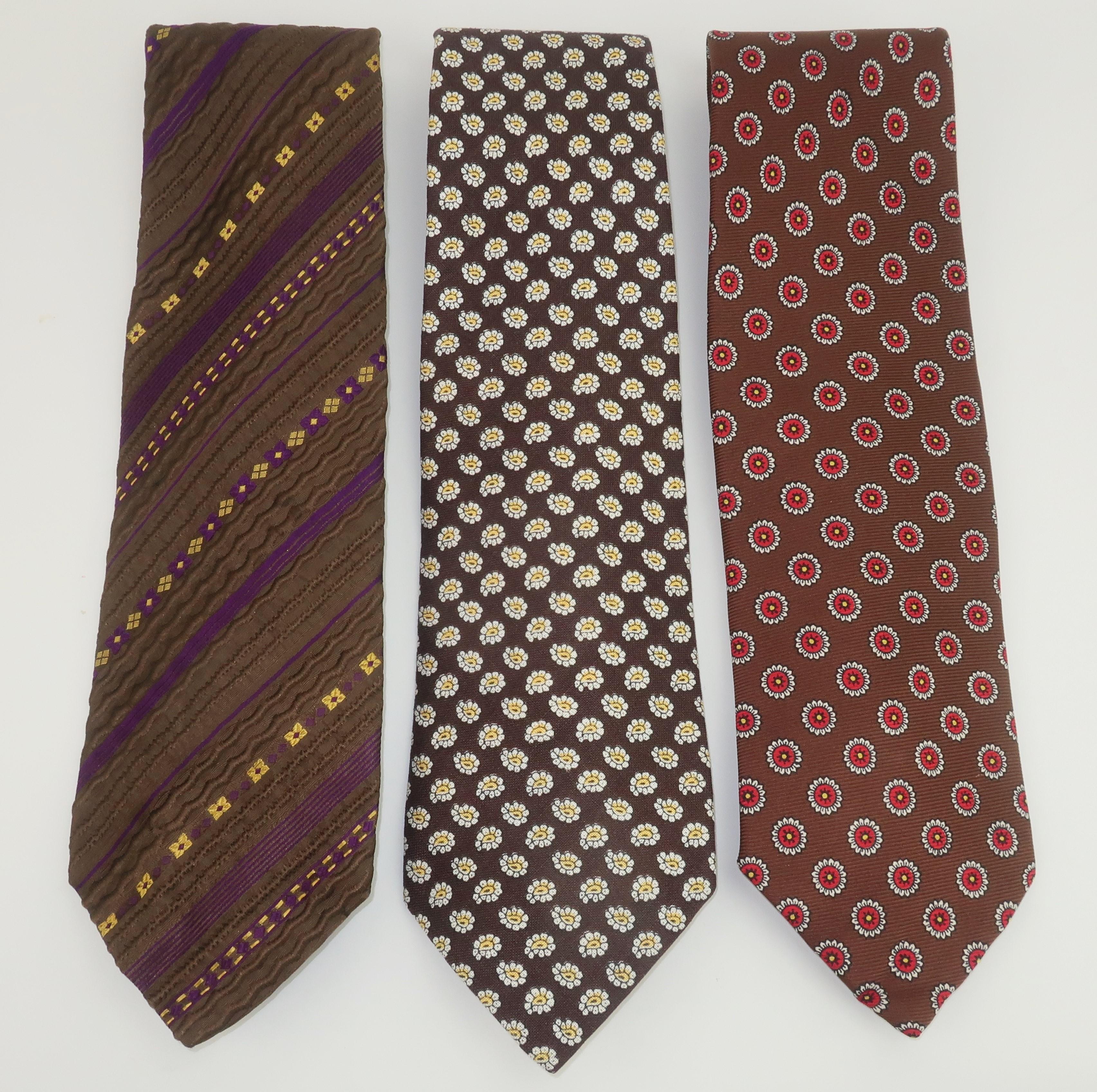 Ralph Lauren started his career designing neckties ... the rest is history!  This collection of wide neckties from the early 1970's represent Lauren's iconic American style.  All three ties are designed in brown silk fabrics with a touch of yellow