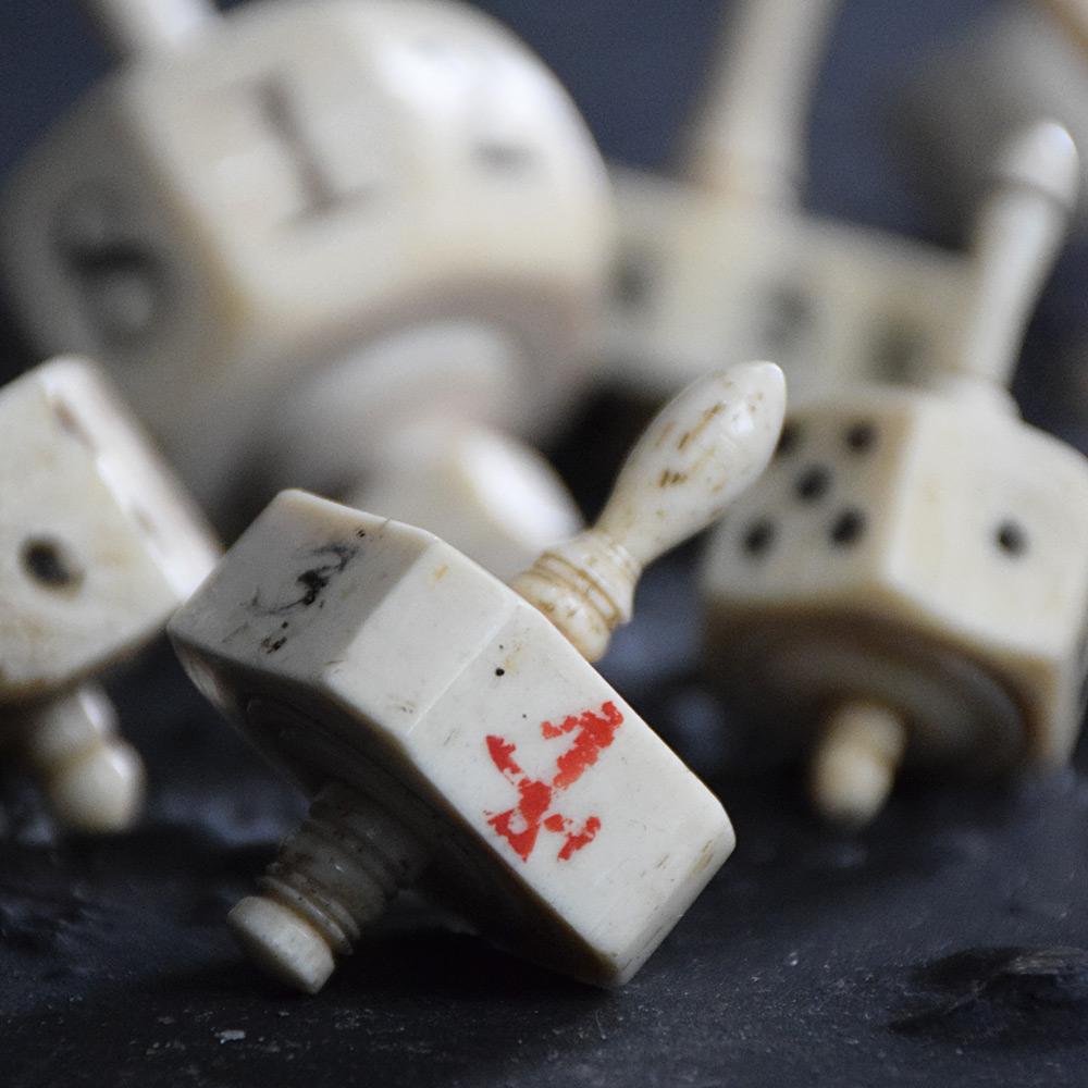 A nice collection of eight 19th century hand crafted bone Teetotum (spinning dice). Of various size and shape. One is exceptionally large. 

Size in inches Approx.: H 3” x W 1.5” x D 1.5” to H 2” x W 0.8” x D 0.8”

Completely solid in structure