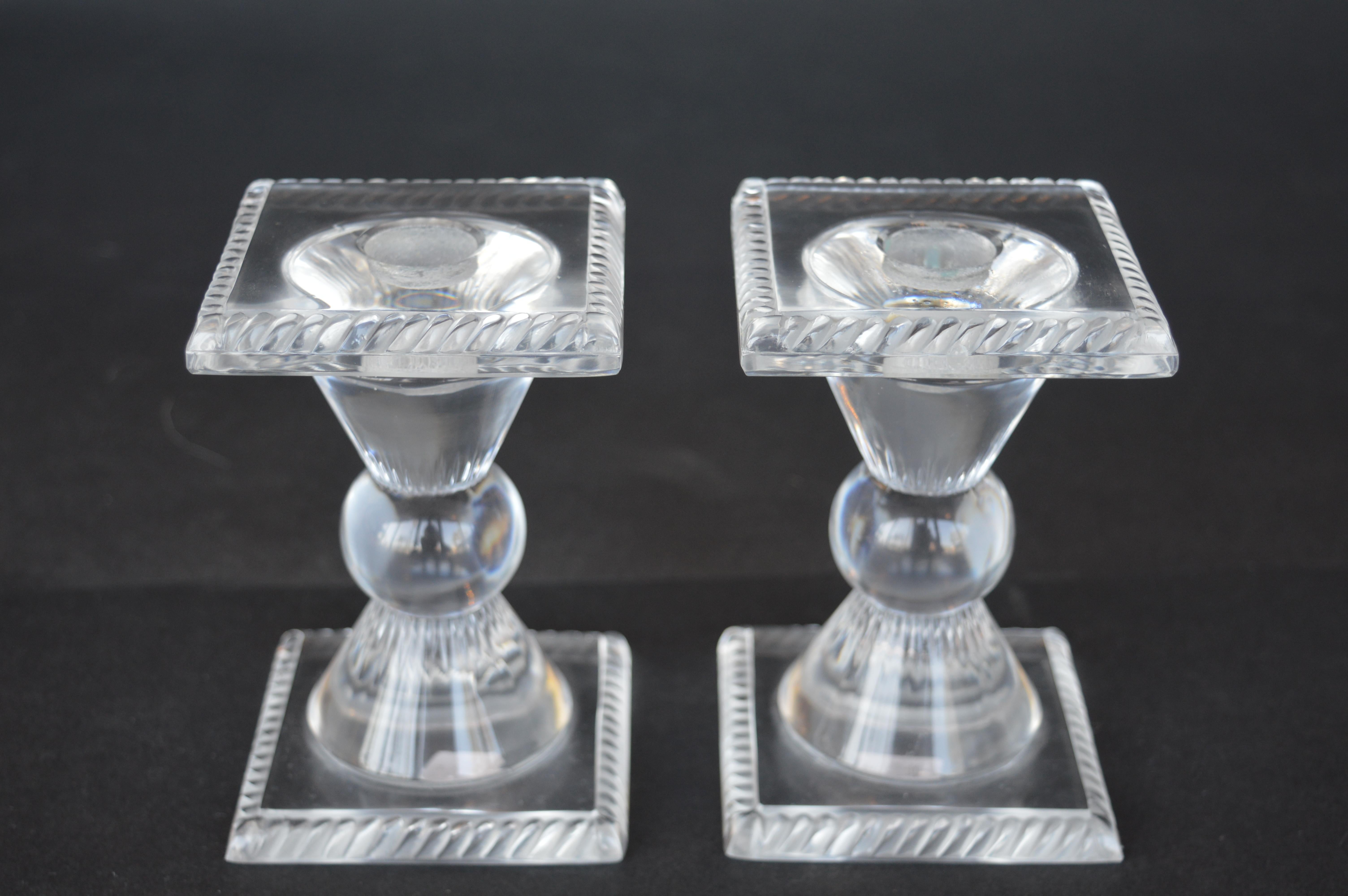 Set of four female Lalique figurines with a pair of Lalique candle sticks.