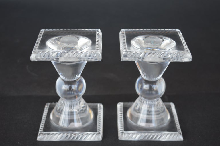 Set of four female Lalique figurines with a pair of Lalique candle sticks.