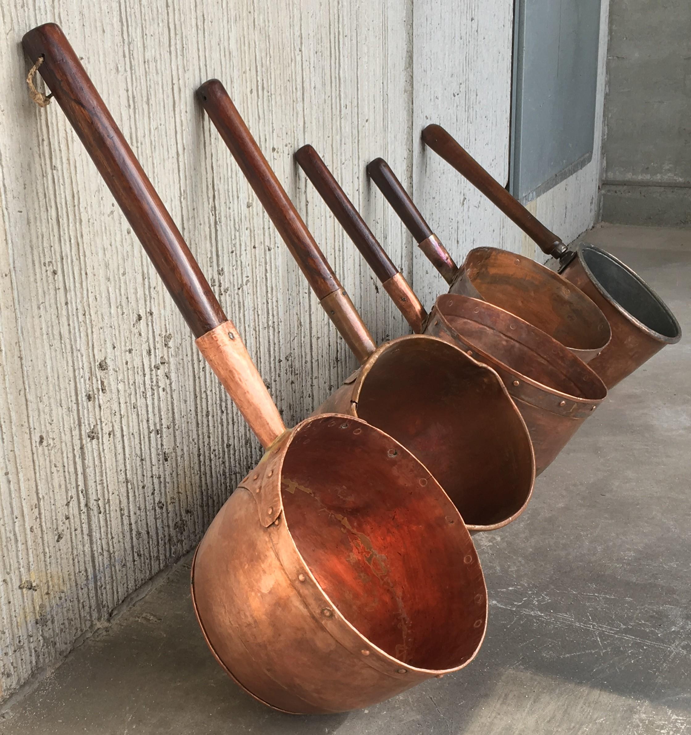 Great collection of antique Spanish handmade and forged copper cook pans - pots from the 1800s. The perfect accessory for your Country Colonial Kitchen. The antique Spanish copper pans were handmade and please not the flat spot in the larger