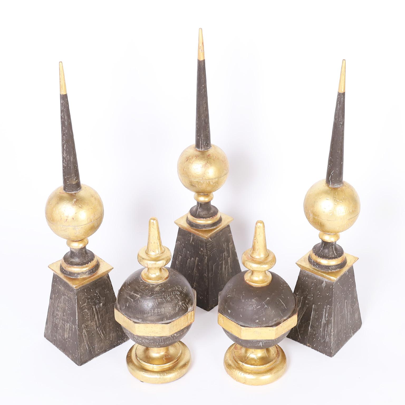 Collection of five wood finials turned and cut with classic form having contrived distressed paint and gold leaf by Las Palmas. Priced individually. 

Taller finials- H: 32.5 W: 7 D: 7 $1,950 each

Shorter finials- H: 18 W: 7 D: 7 $1050.
