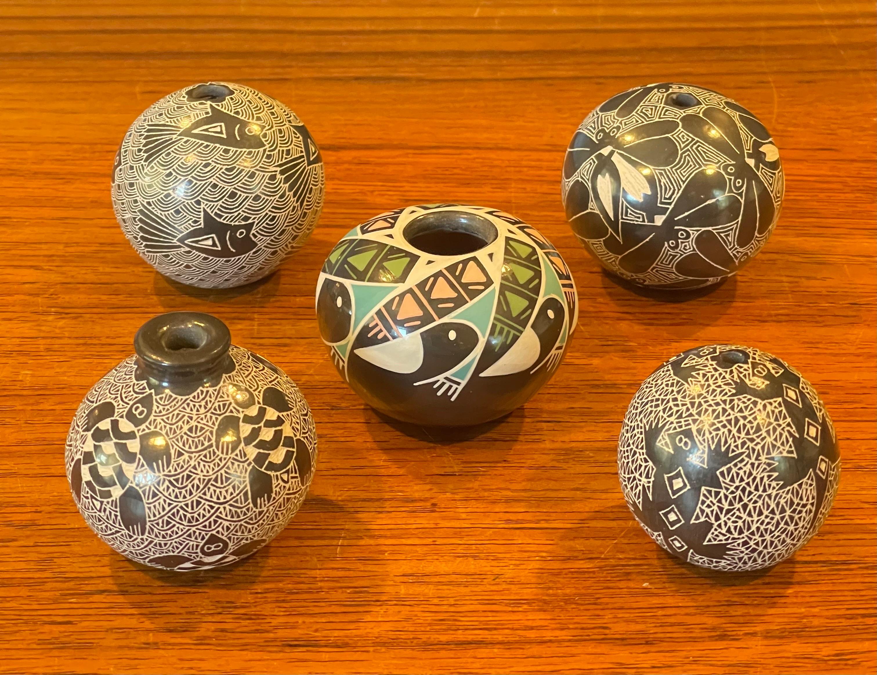 A very nice collection of five miniature Mata Ortiz pottery ollas / seed pots, circa 1990s. Each pot has exquisite detail and is signed on the underside.  They are in very good condition with no chips or cracks and measures a approximately 2