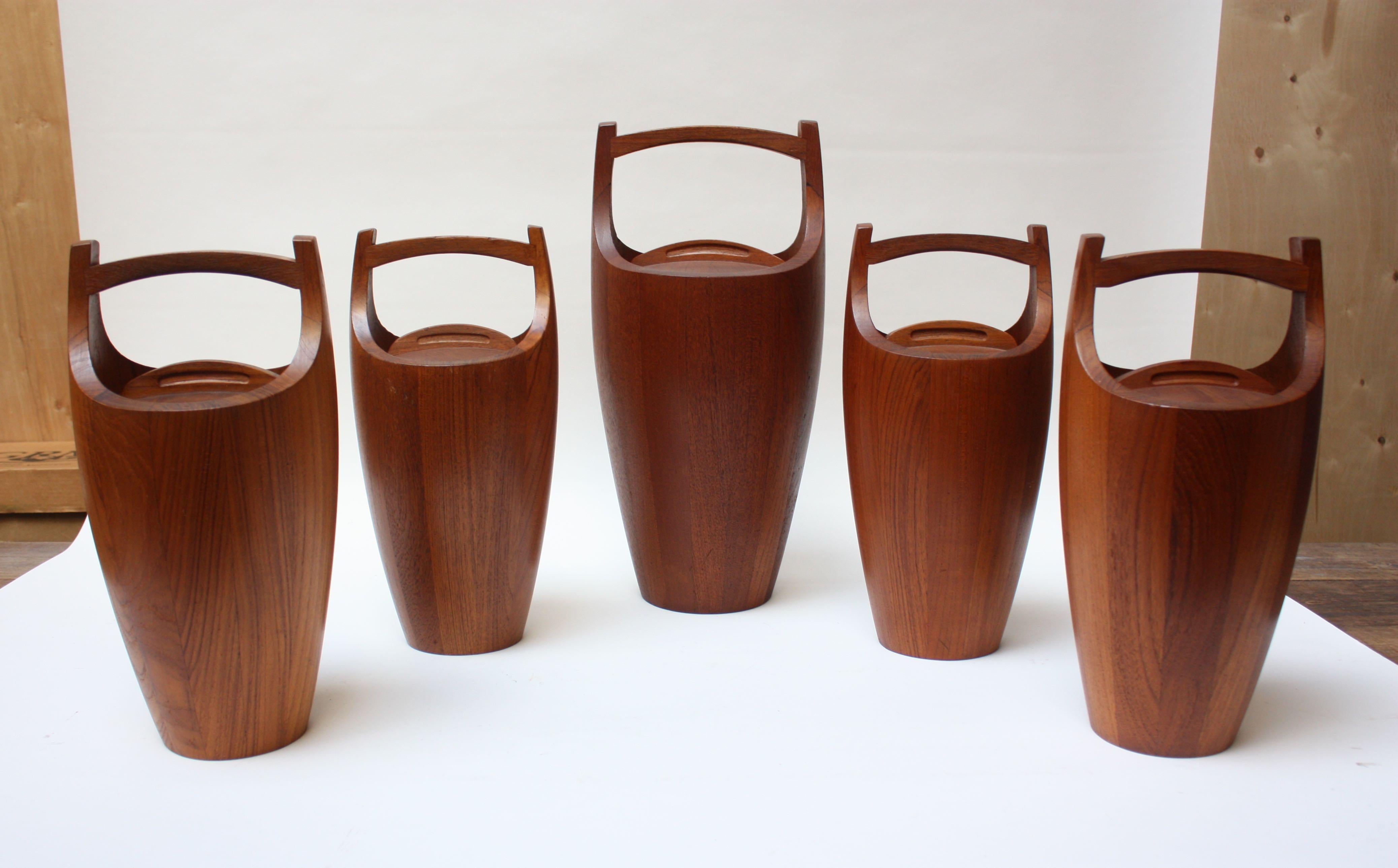Set of four standard size and one large Dansk 'Congo' ice buckets in staved teak designed by Jens Quistgaard for Dansk. All are early Dansk Designs Denmark examples with orange plastic interior liners. Iconic, sculptural pieces being sold together