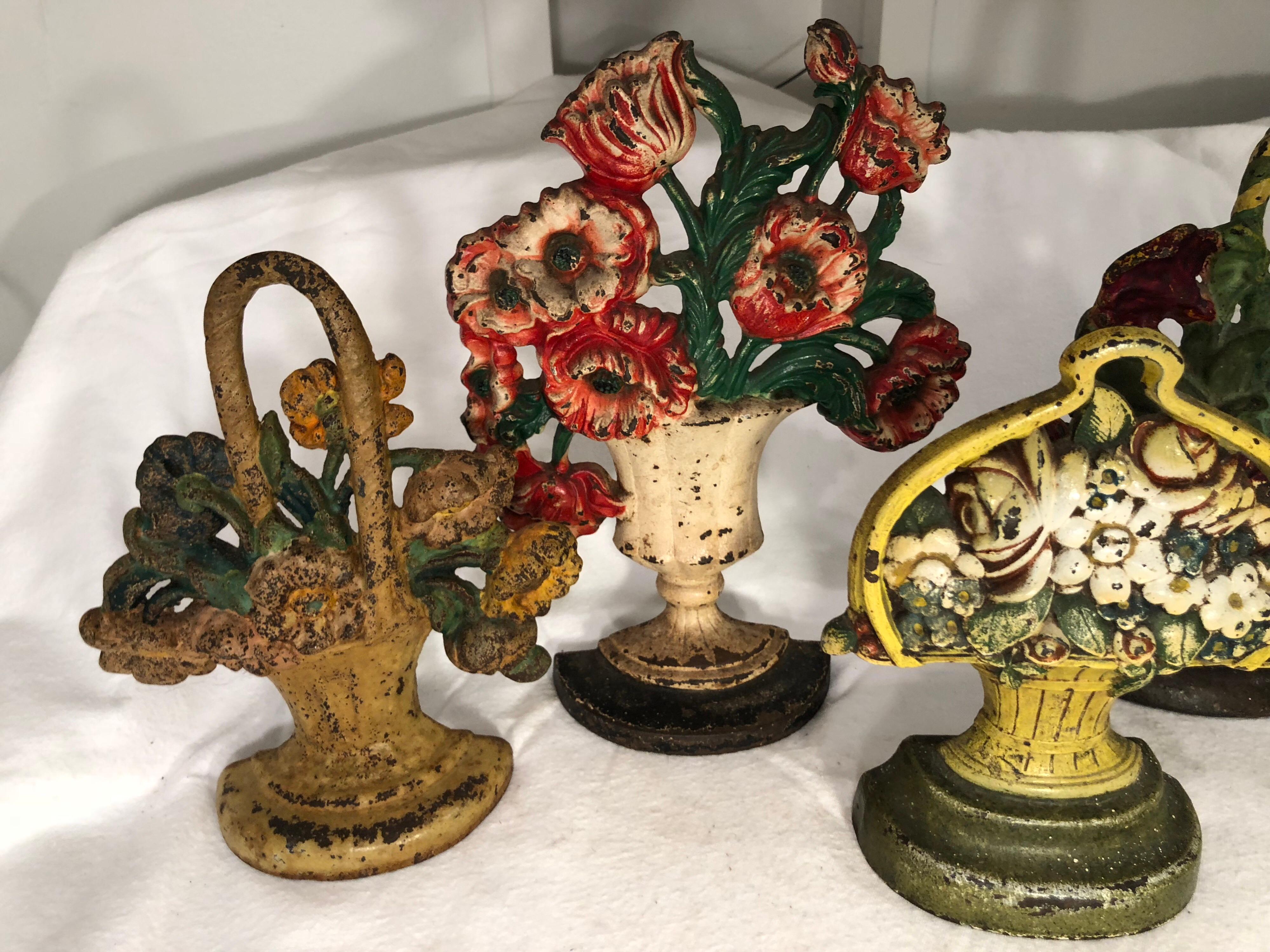 Collection of floral cast iron bookends. Five total. Varying designs of floral baskets. Use as doorstops or bookends. Or just display them as the beautiful pieces of art that they are. The styles vary from Victorian to Art Deco, to Arts & Crafts to