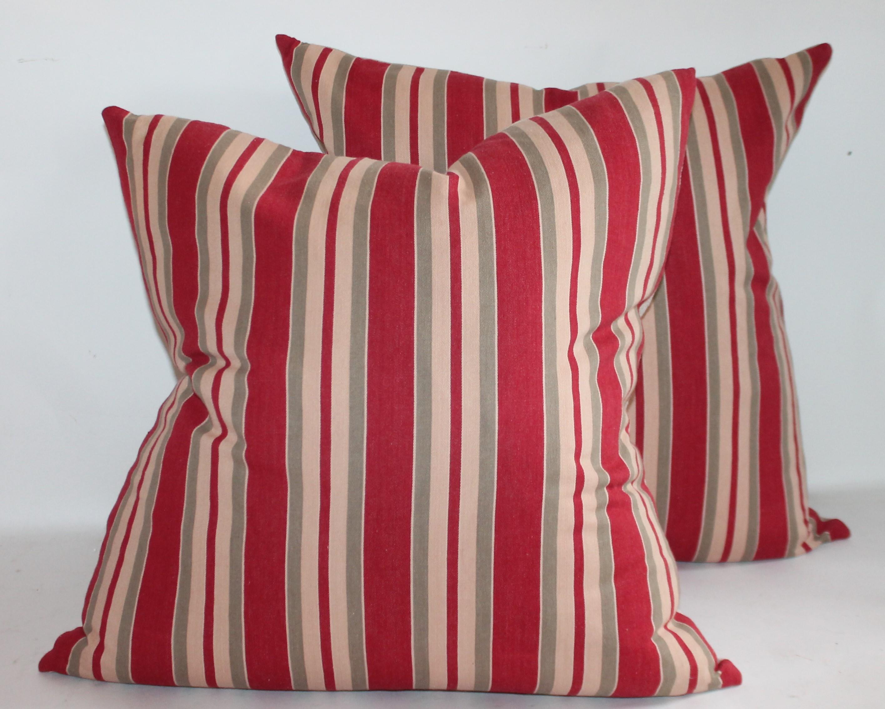 These fantastic vintage French ticking pillows have cotton linen backing and in fine condition. Down and feather fill. Two pairs of pillows.